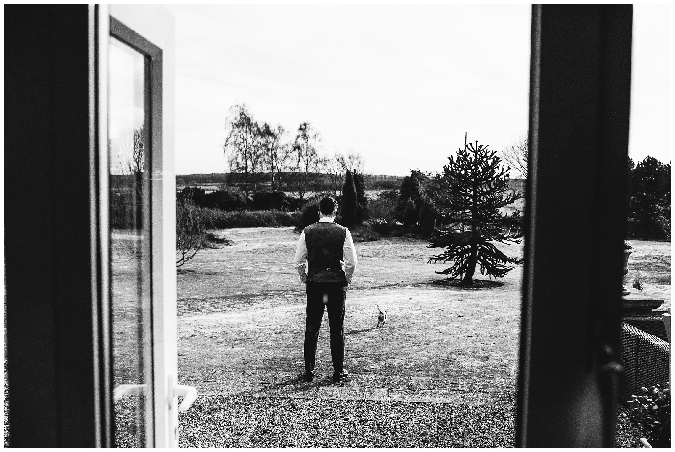 groom and his dog looking at landscape