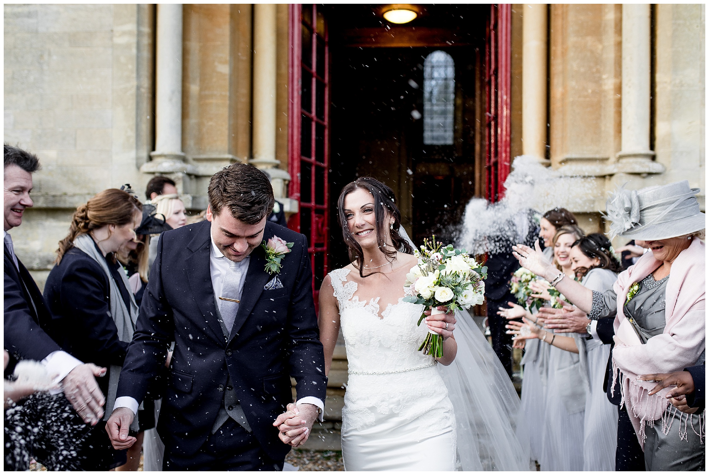 bride and groom use snow as confetti at woburn abbey