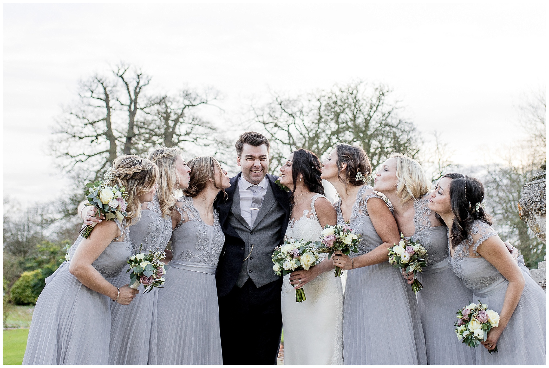 bridesmaids all kiss groom at a woburn sculpture gallery wedding