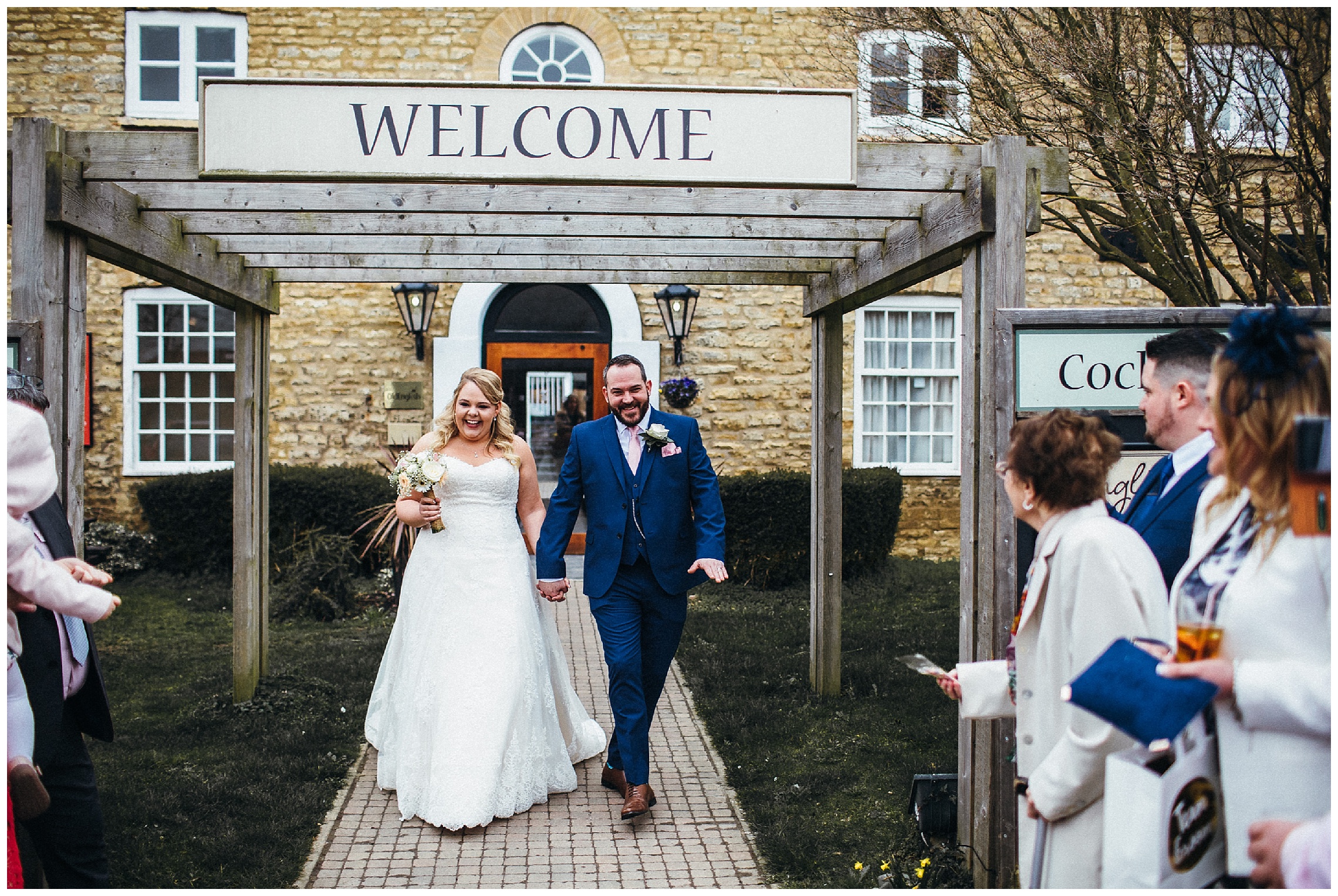 bride and groom exit at the cock hotel