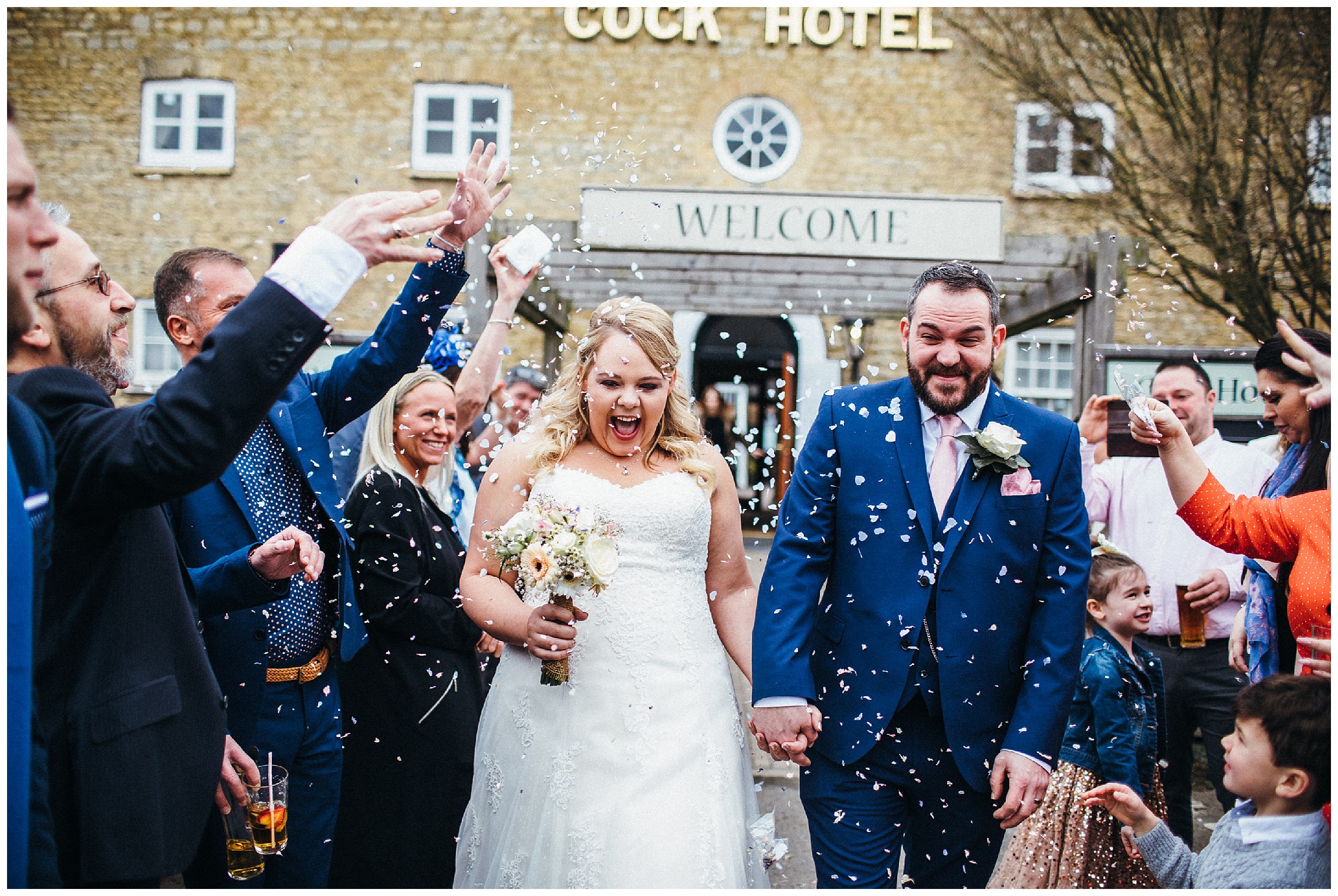 bride and groom with confetti at the cock hotel