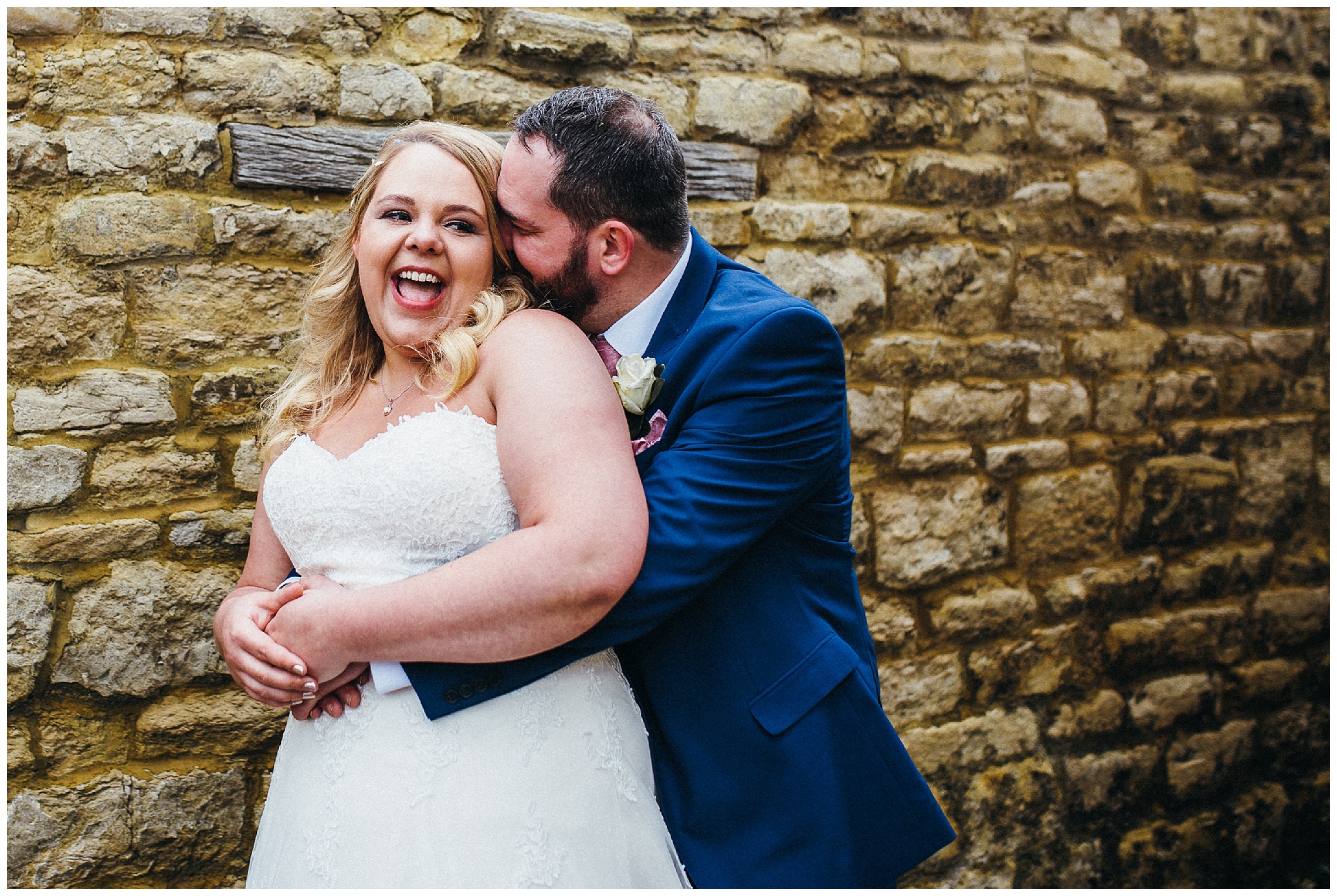 bride and groom cuddling at cock hotel