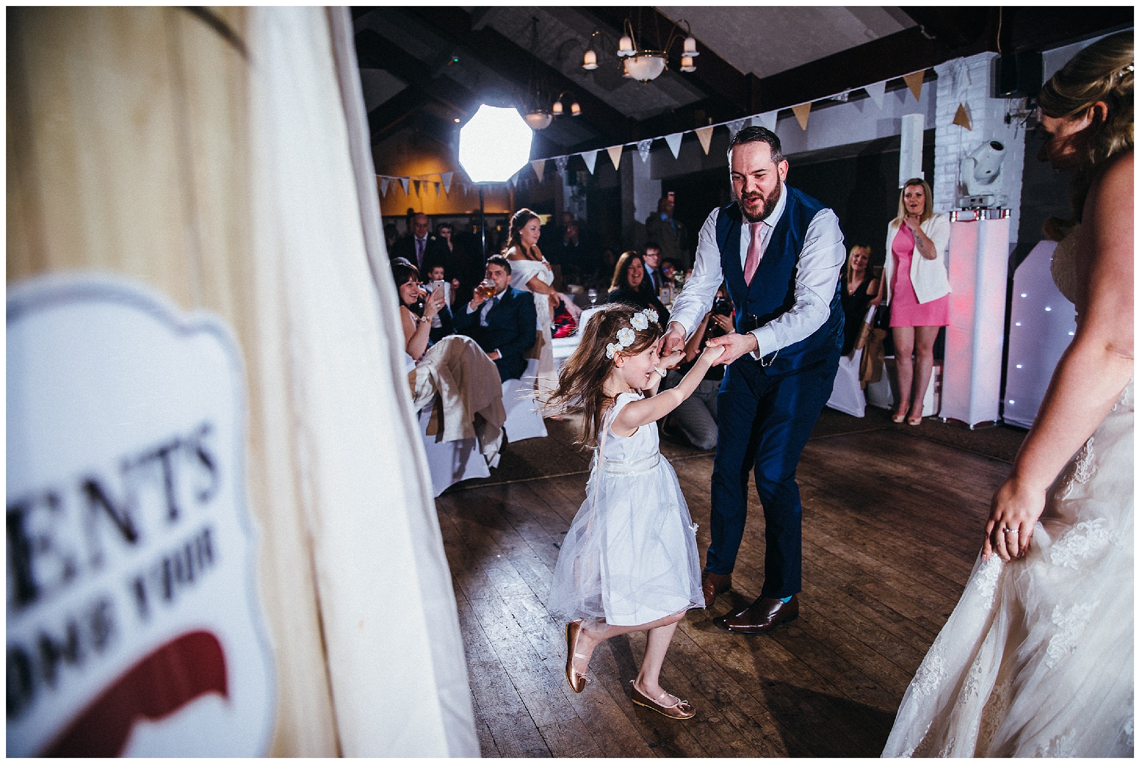 flower girl dances with her dad at the cock hotel in stony stratford