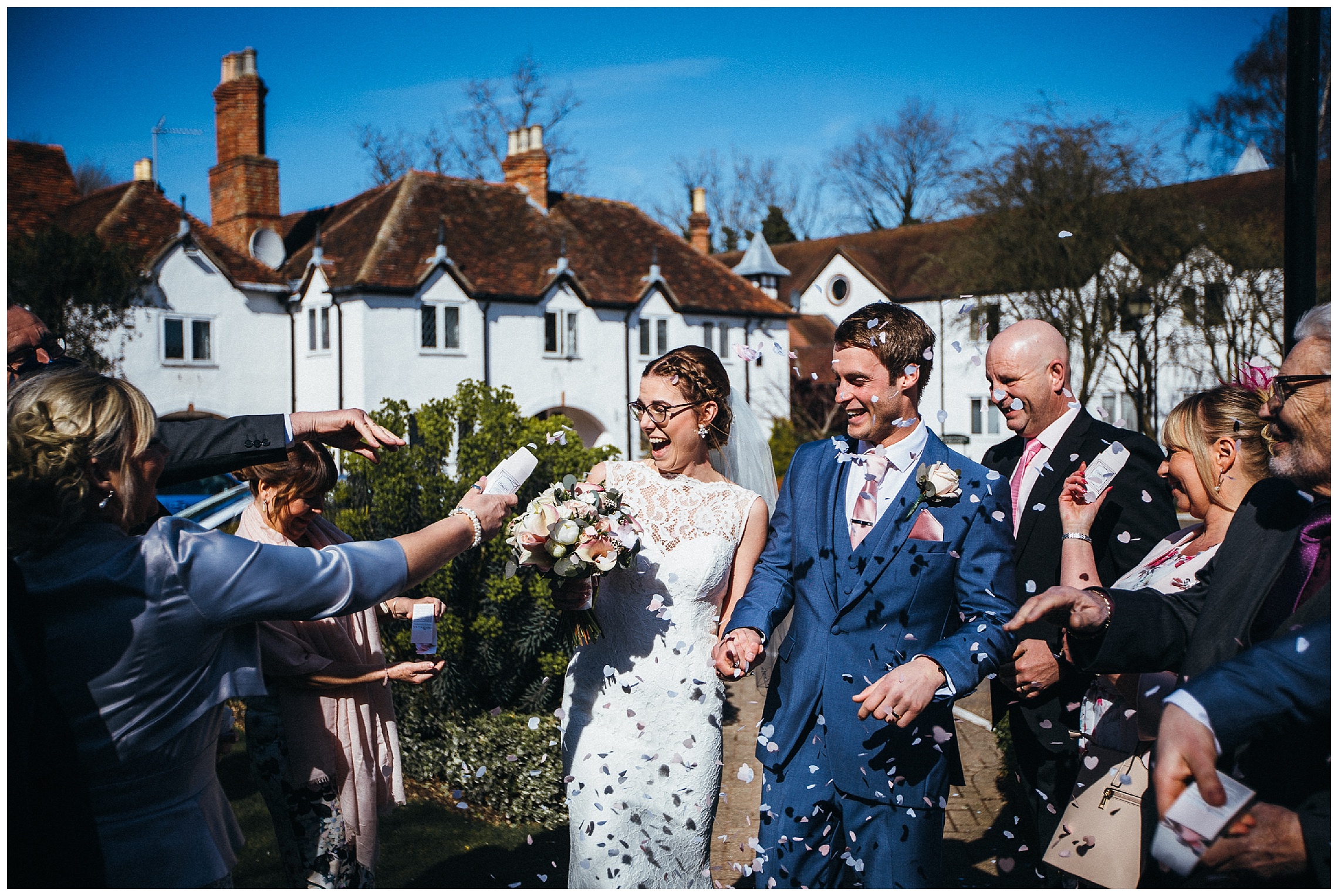 bride and groom getting confetti thrown at them at the barns hotel
