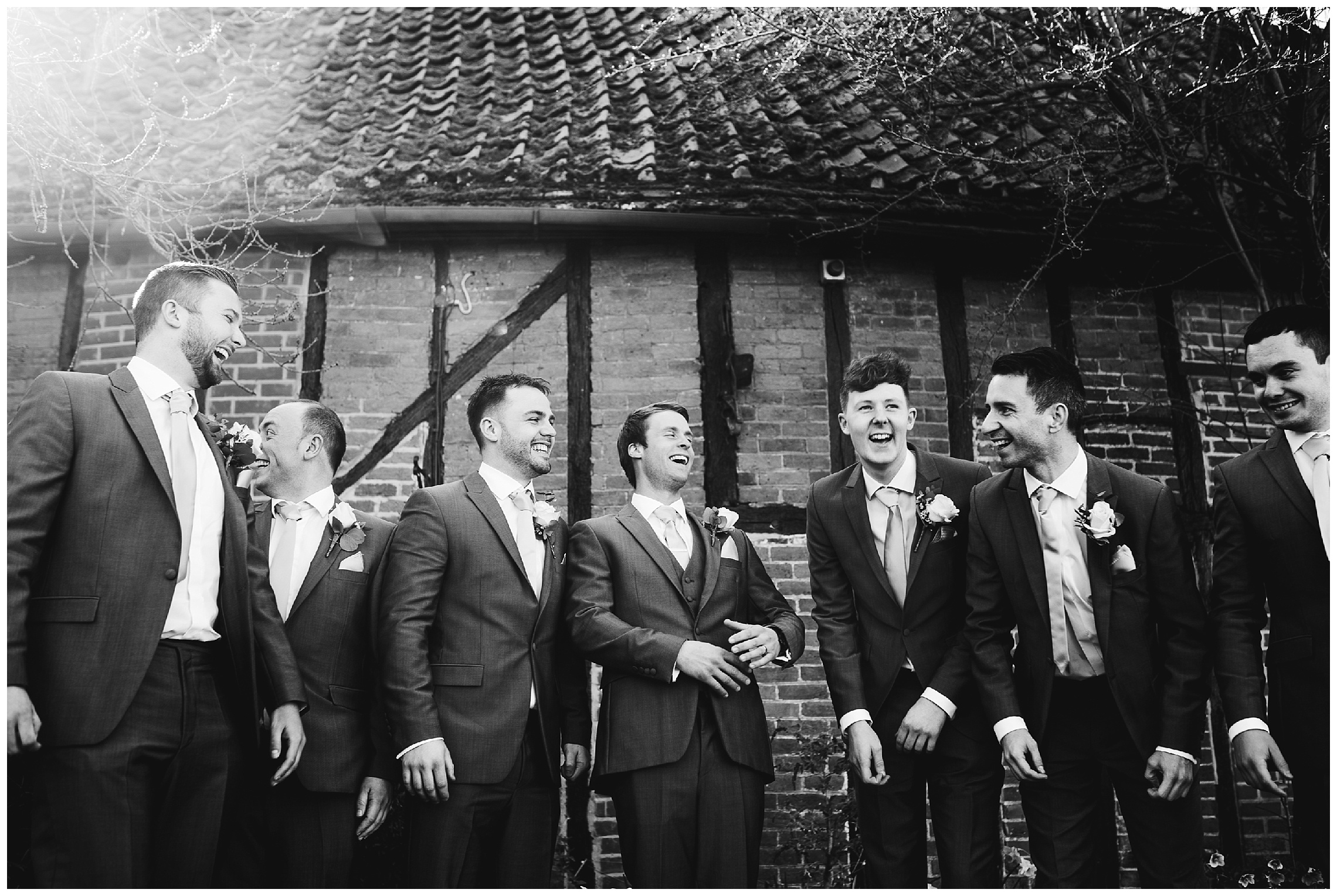 groomsmen laughing at the barns hotel