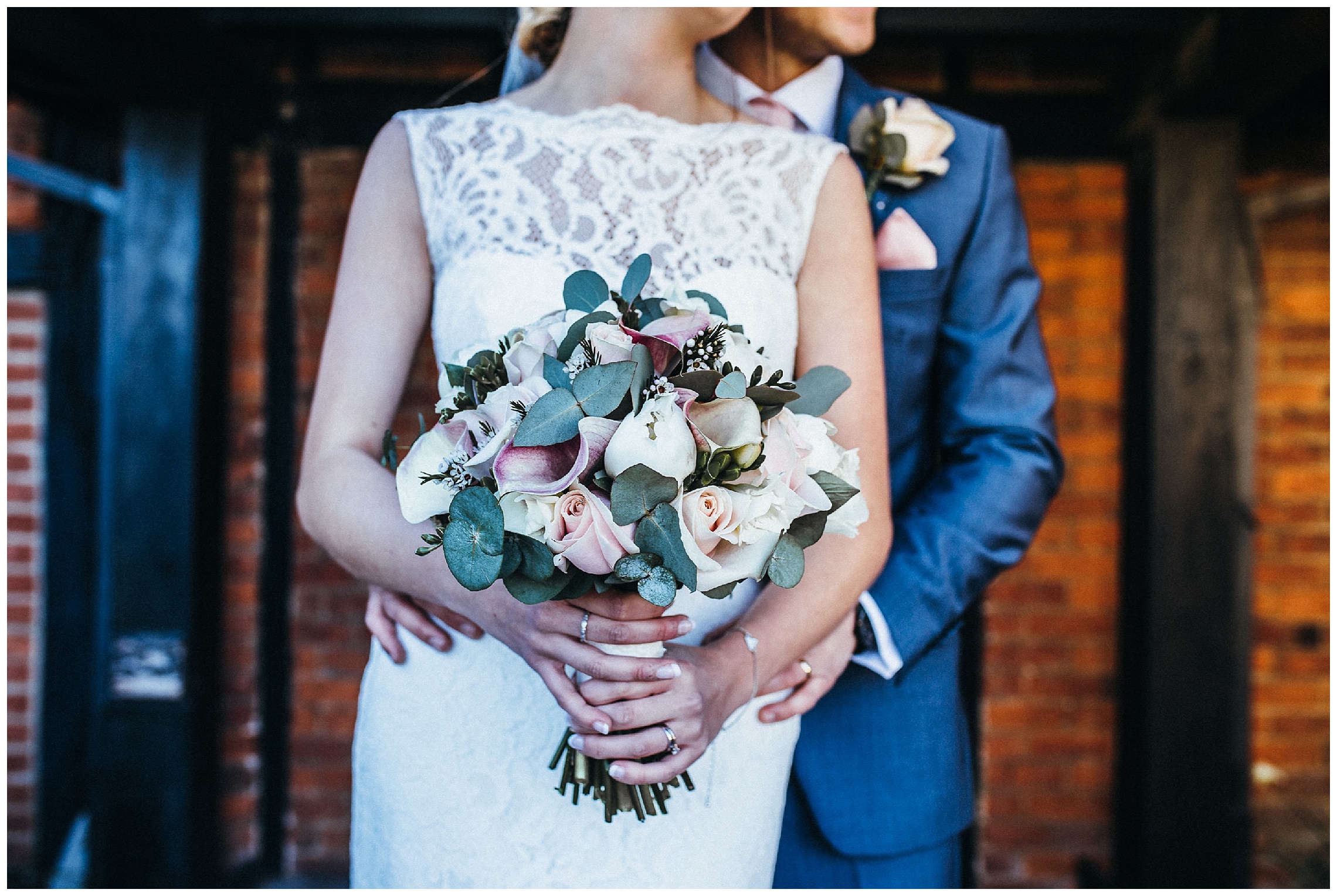 bride and groom portrait with brides bouquet at the barns