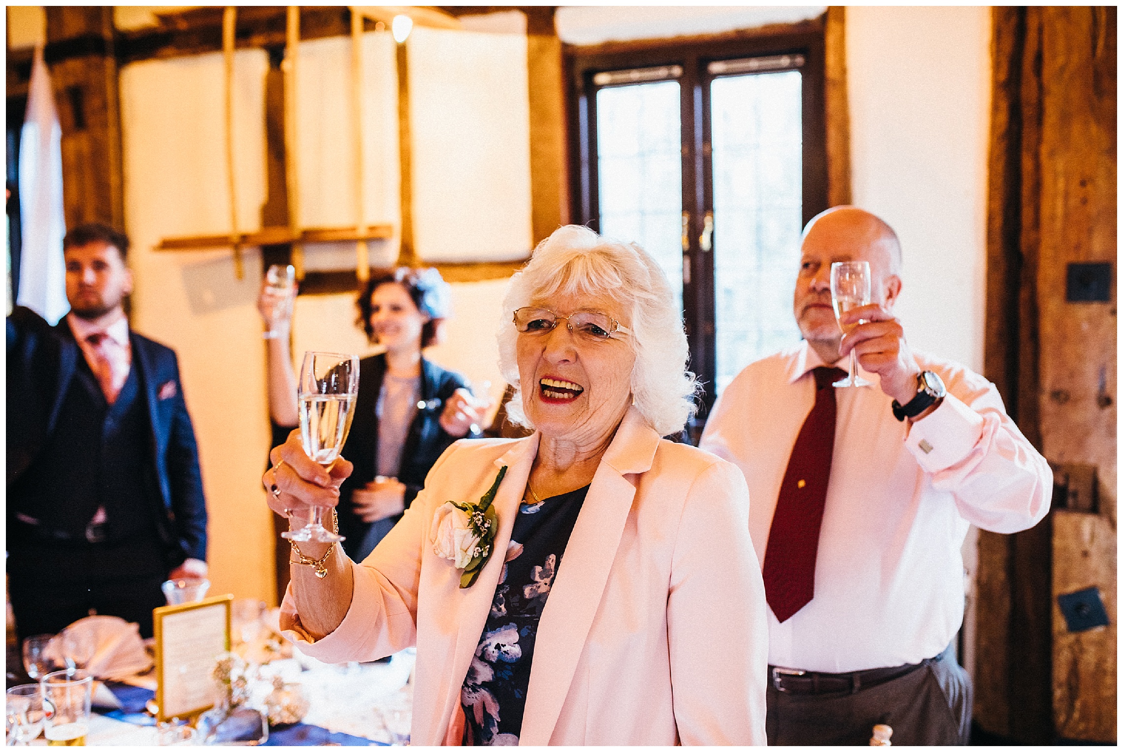 grandma toasts to the new bride and groom with champagne