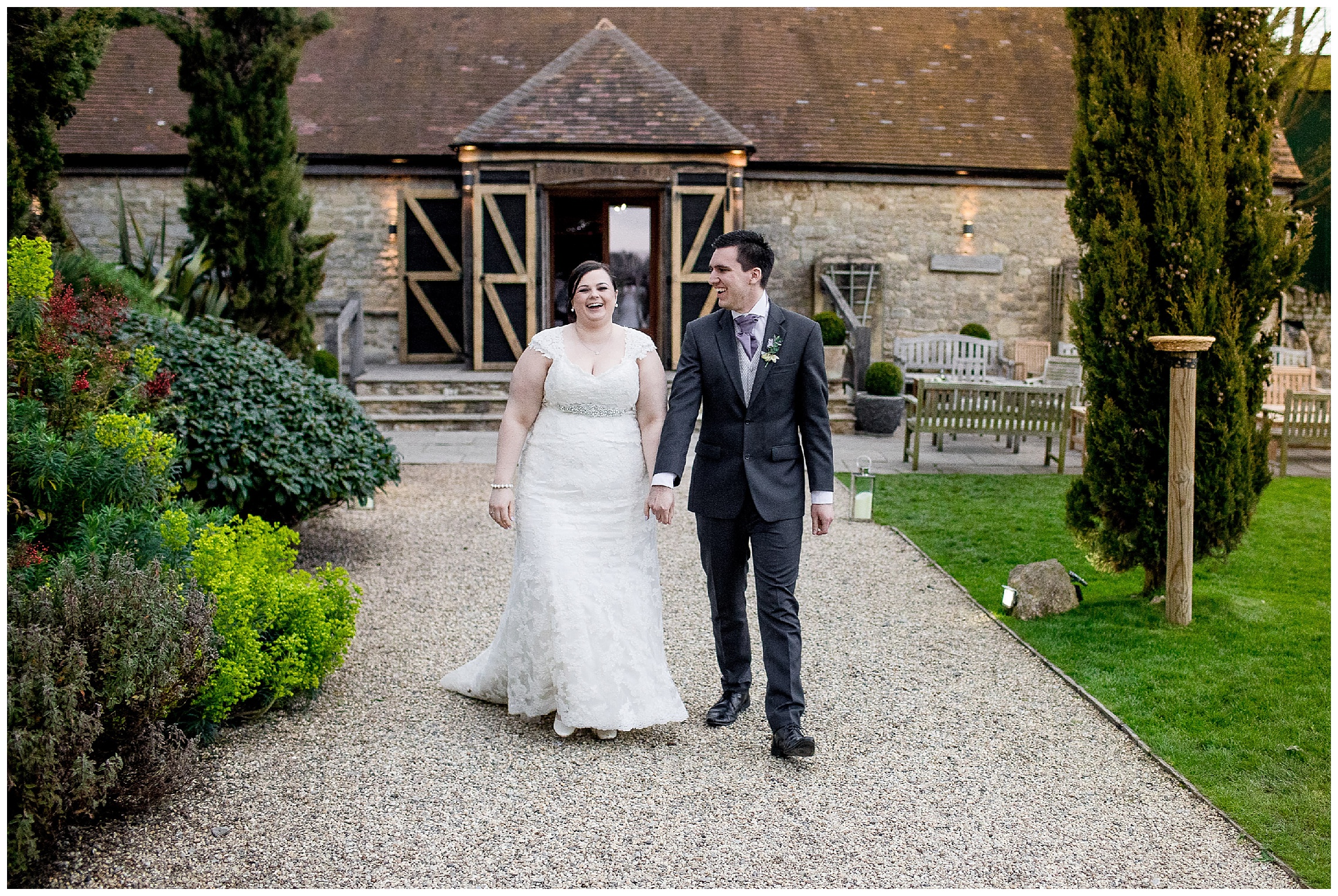 bride and groom walk hand in hand at notley tythe barn wedding