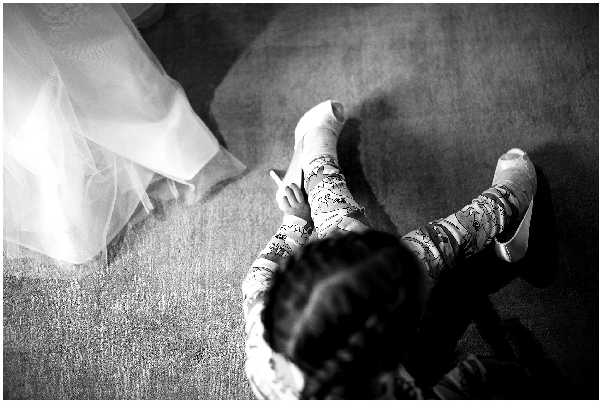 flower girl tries on the brides shoes