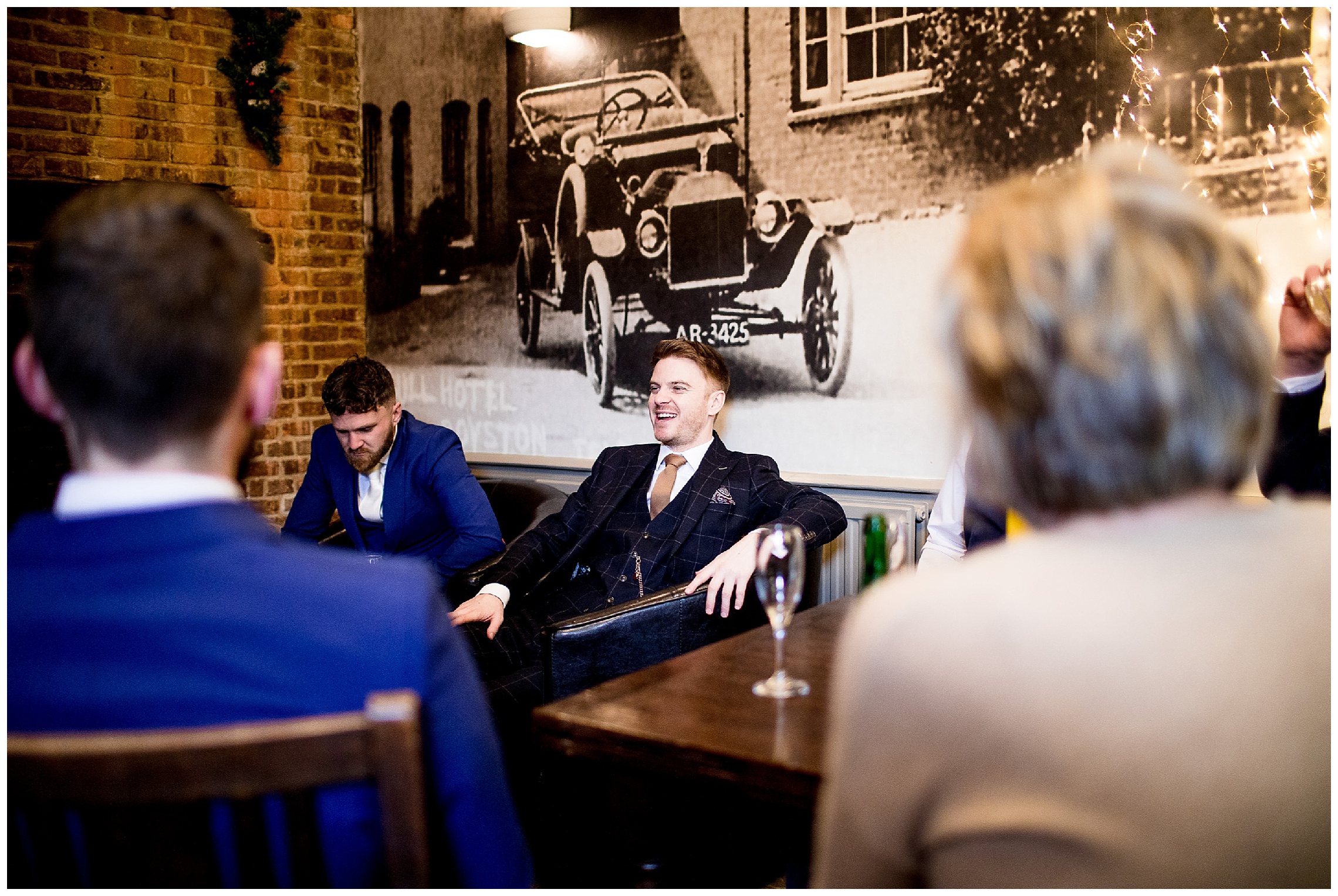 groom at the old bull in laughing with friends