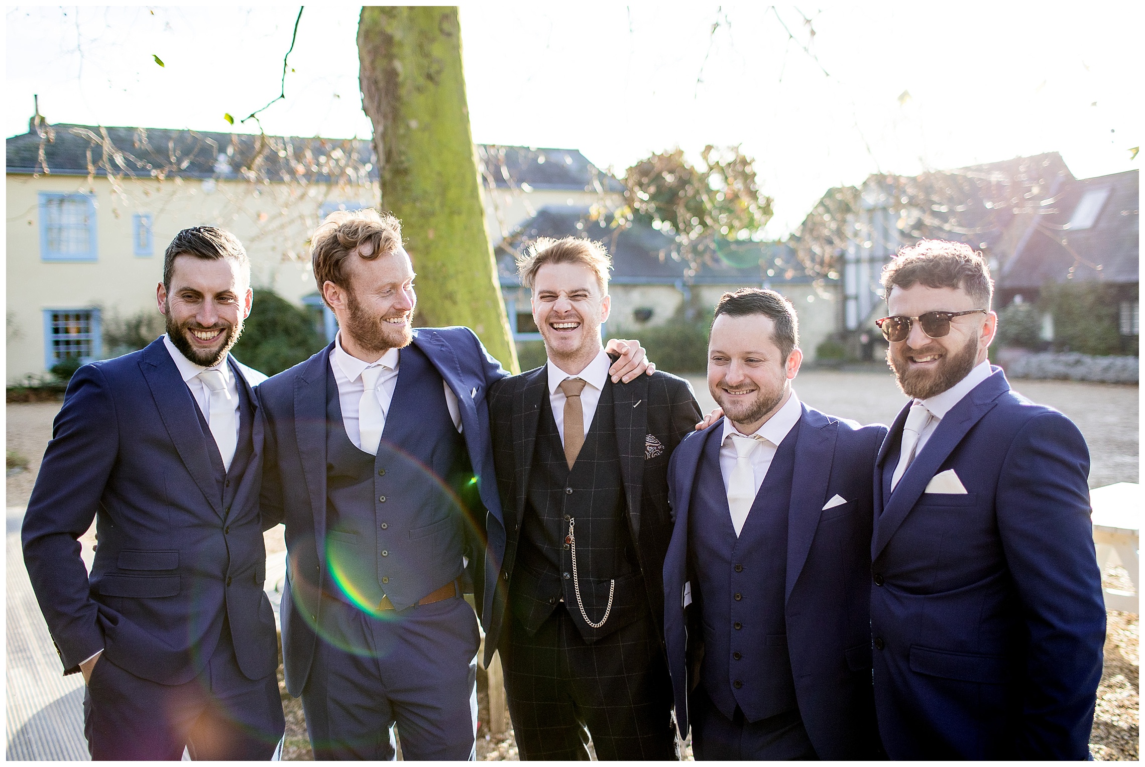 groomsmen in the courtyard laughing at south farm