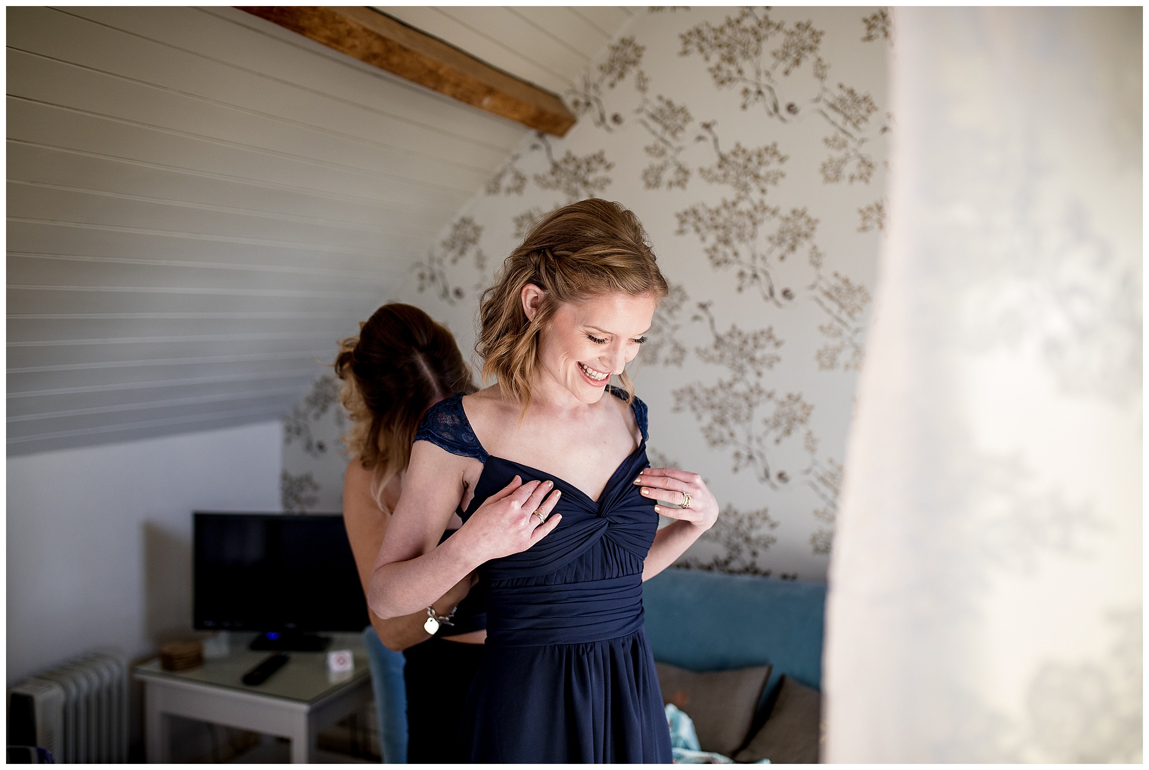 bridesmaid getting into her navy dress at south farm