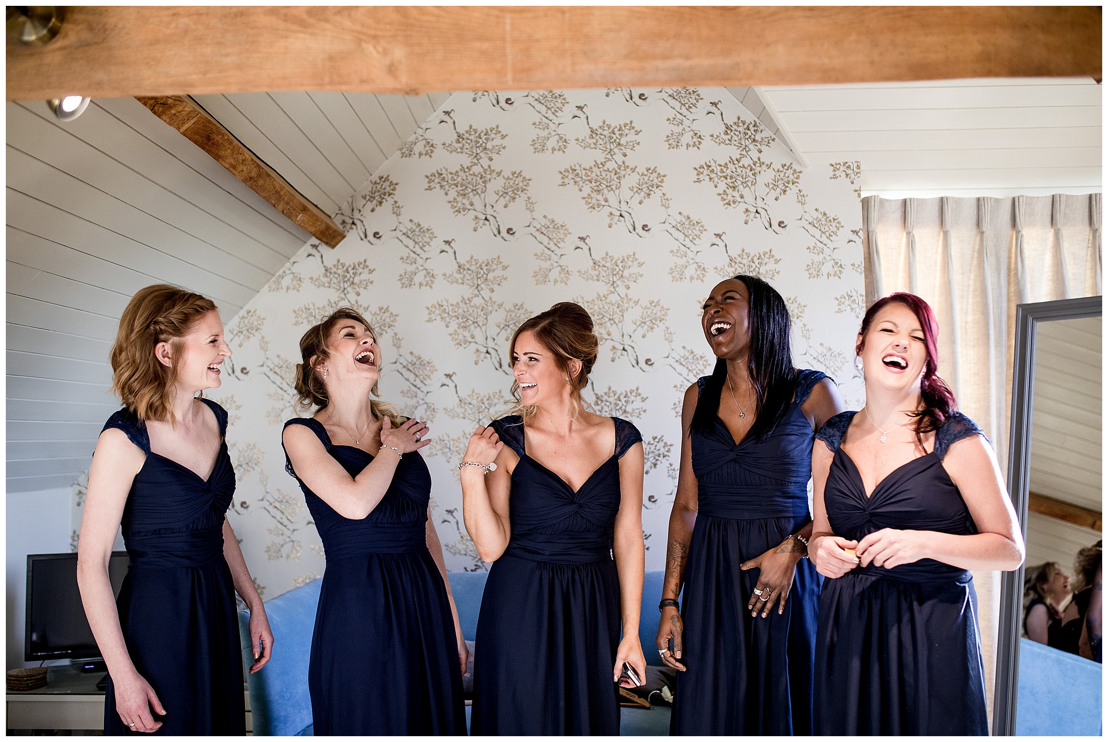 bridesmaids in the bridal boudoir in navy cap sleeve dresses
