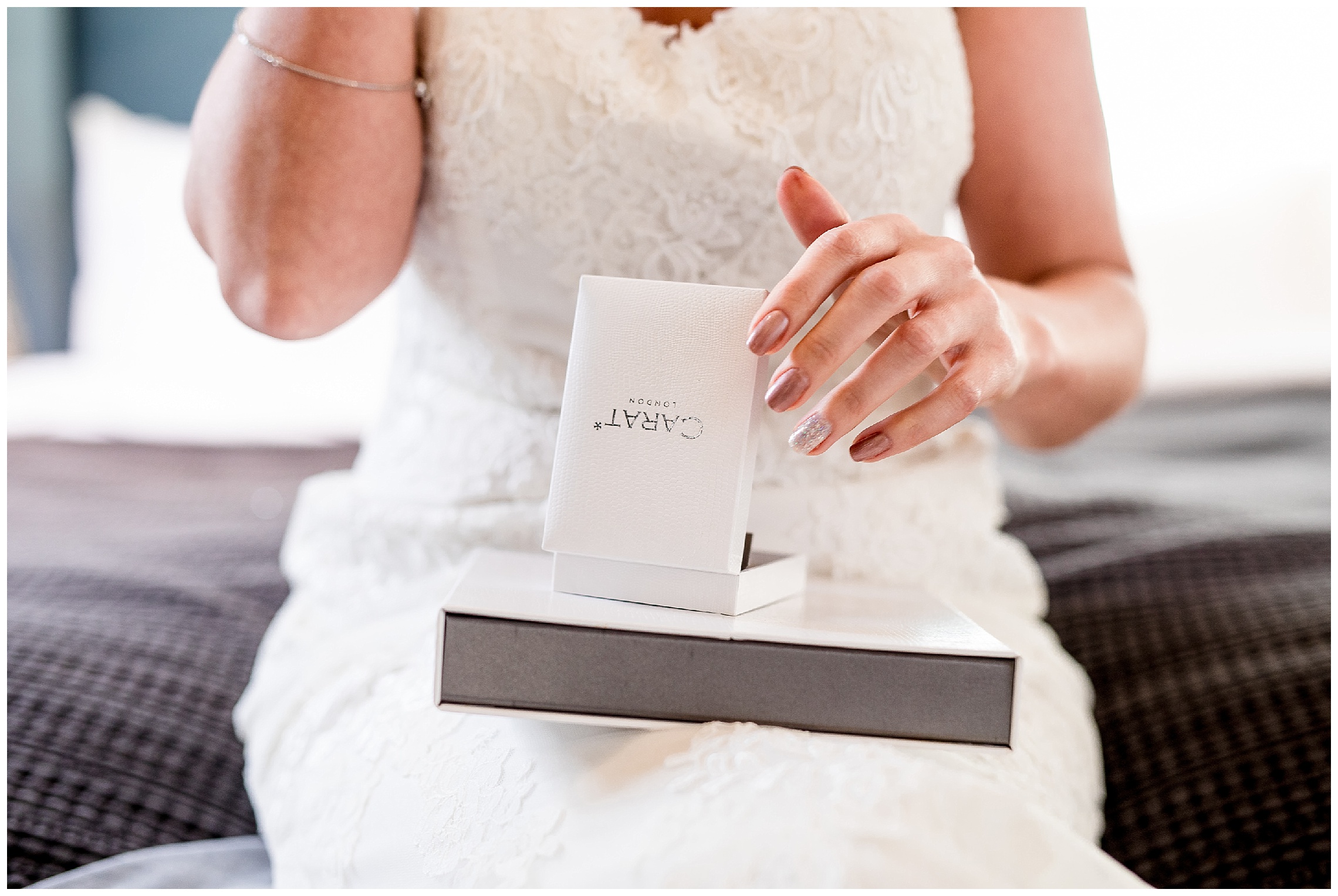 bride takes a moment to put on her jewellery