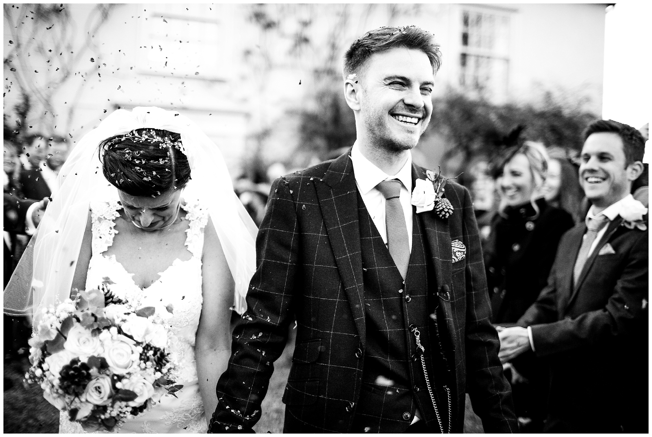 confetti is thrown over bride and groom at south farm wedding