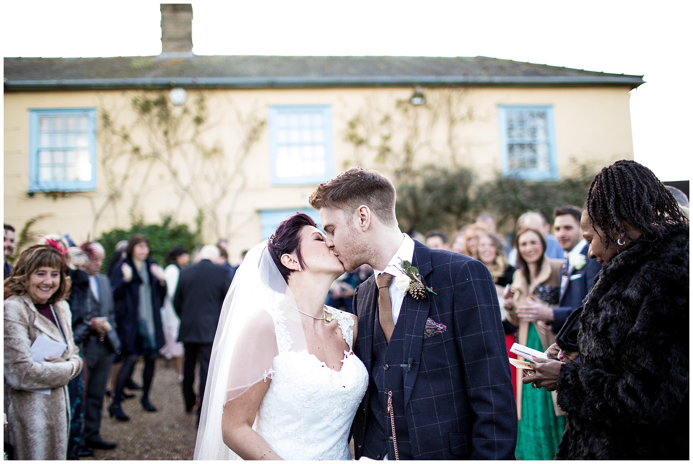 bride and groom kiss after confetti at south farm