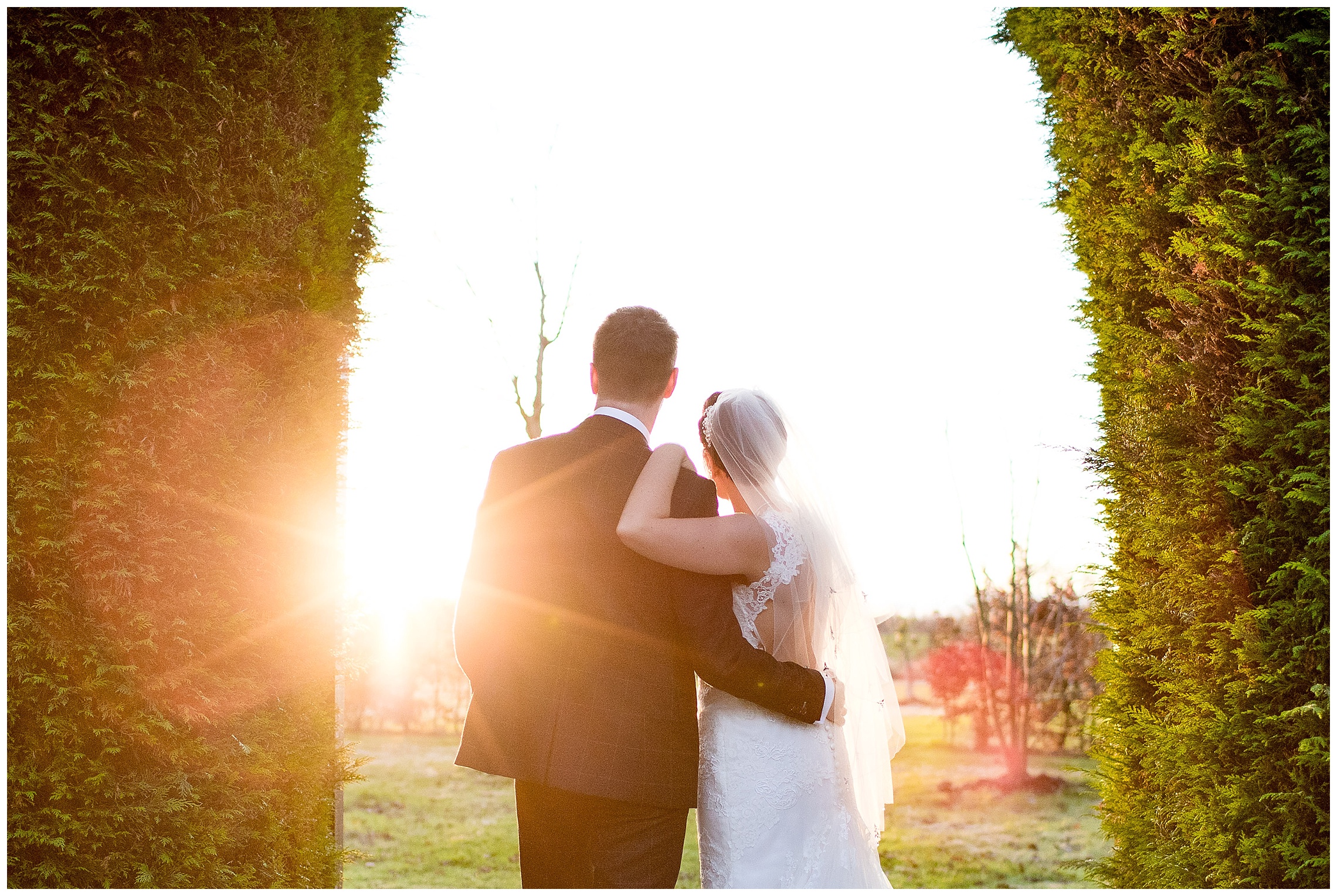 Bride and groom watch the sunset in the garden at south farm wedding venue