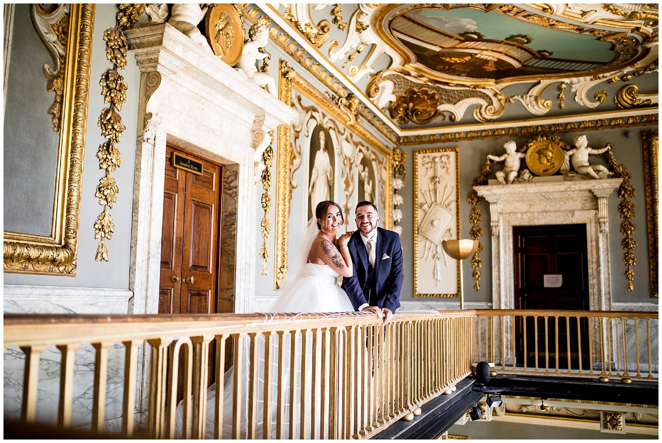 bride and groom stand together leaning against bannister in hallway at Moor Park wedding venue