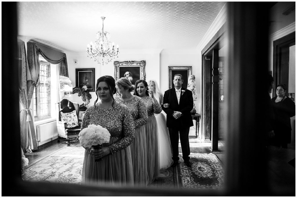 Bridesmaids and bride with her father waiting outside the door to enter wedding ceremony at plum park 
