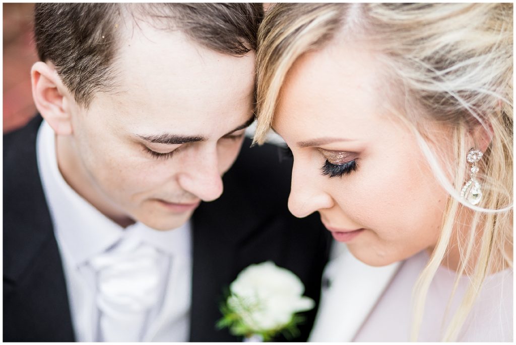 Bride and groom close up of eyes as they look down at each other. 