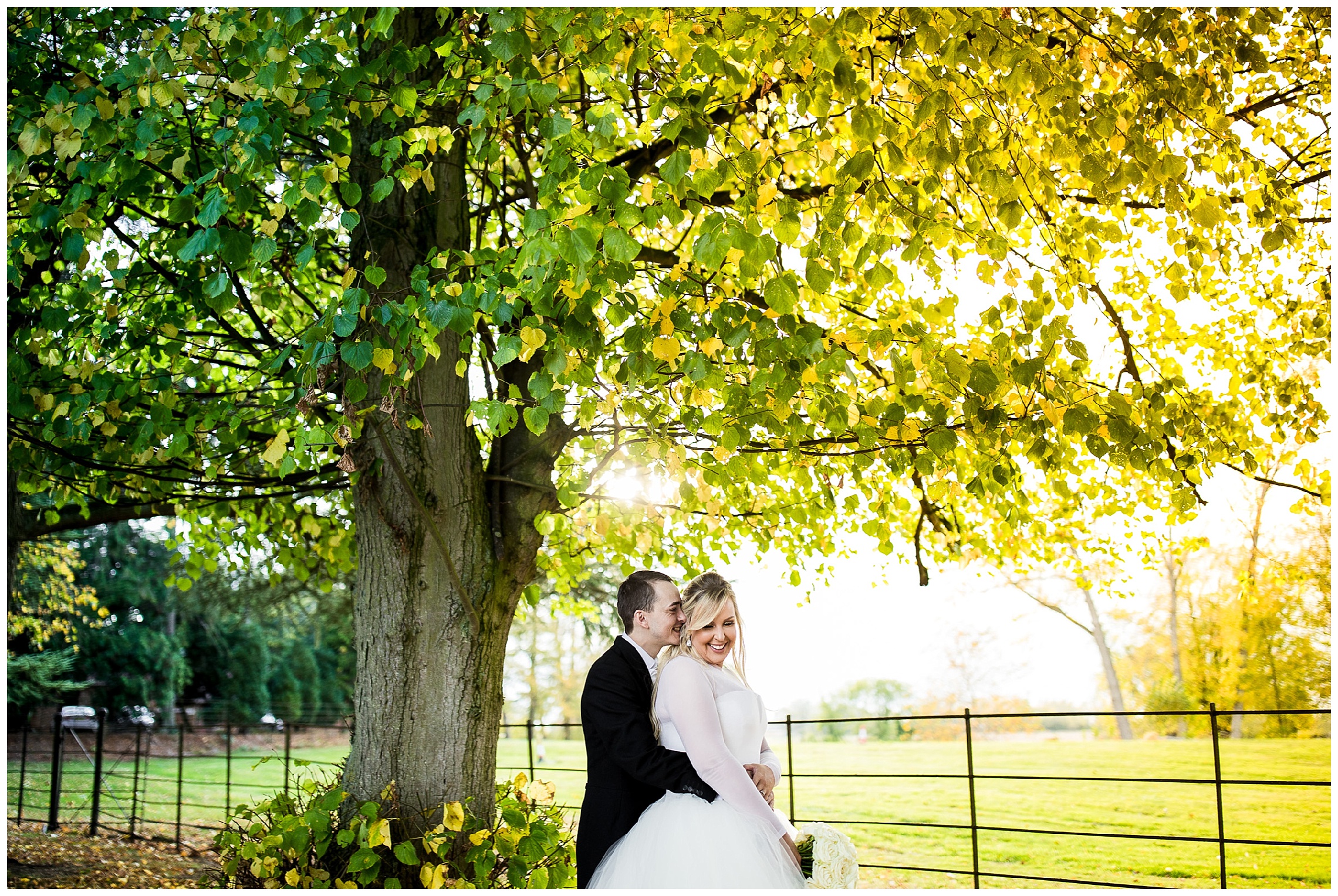 bride and groom stand close together and bride laughs