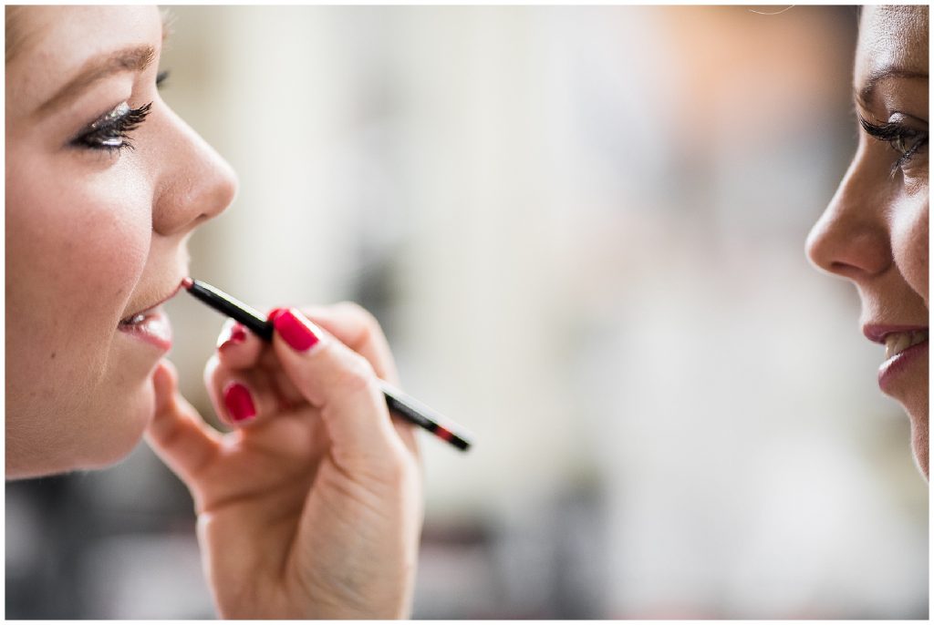 bride having lipstick applied 