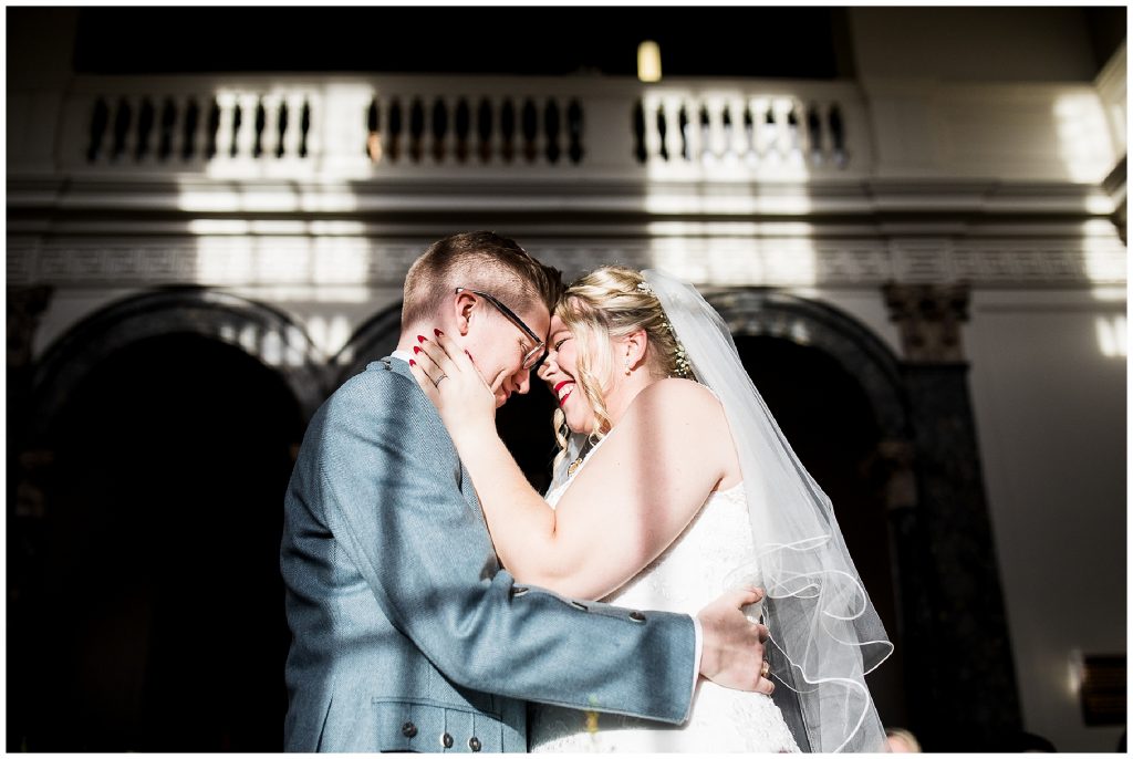 light shines on bride and groom as they say vows at chicheley hall