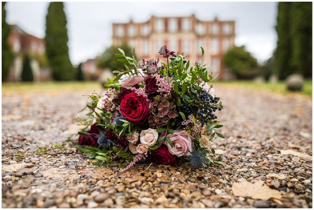 autumnal red flower bouquet in front of chicheley hall