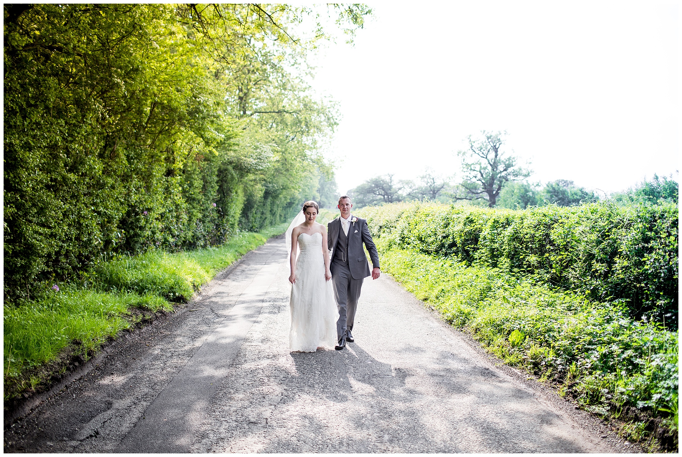 bride and groom walking down road