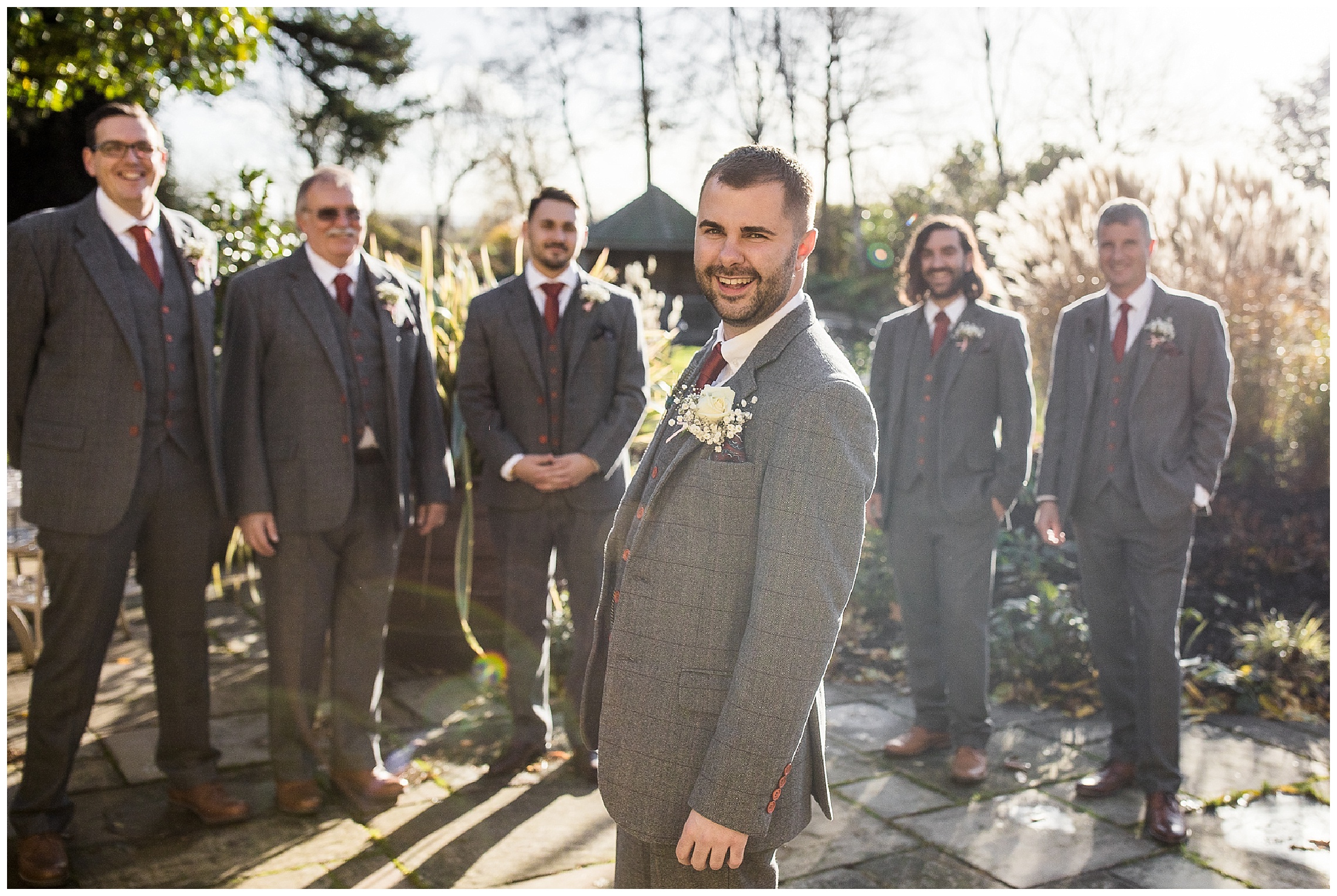 groom standing in front of groomsmen