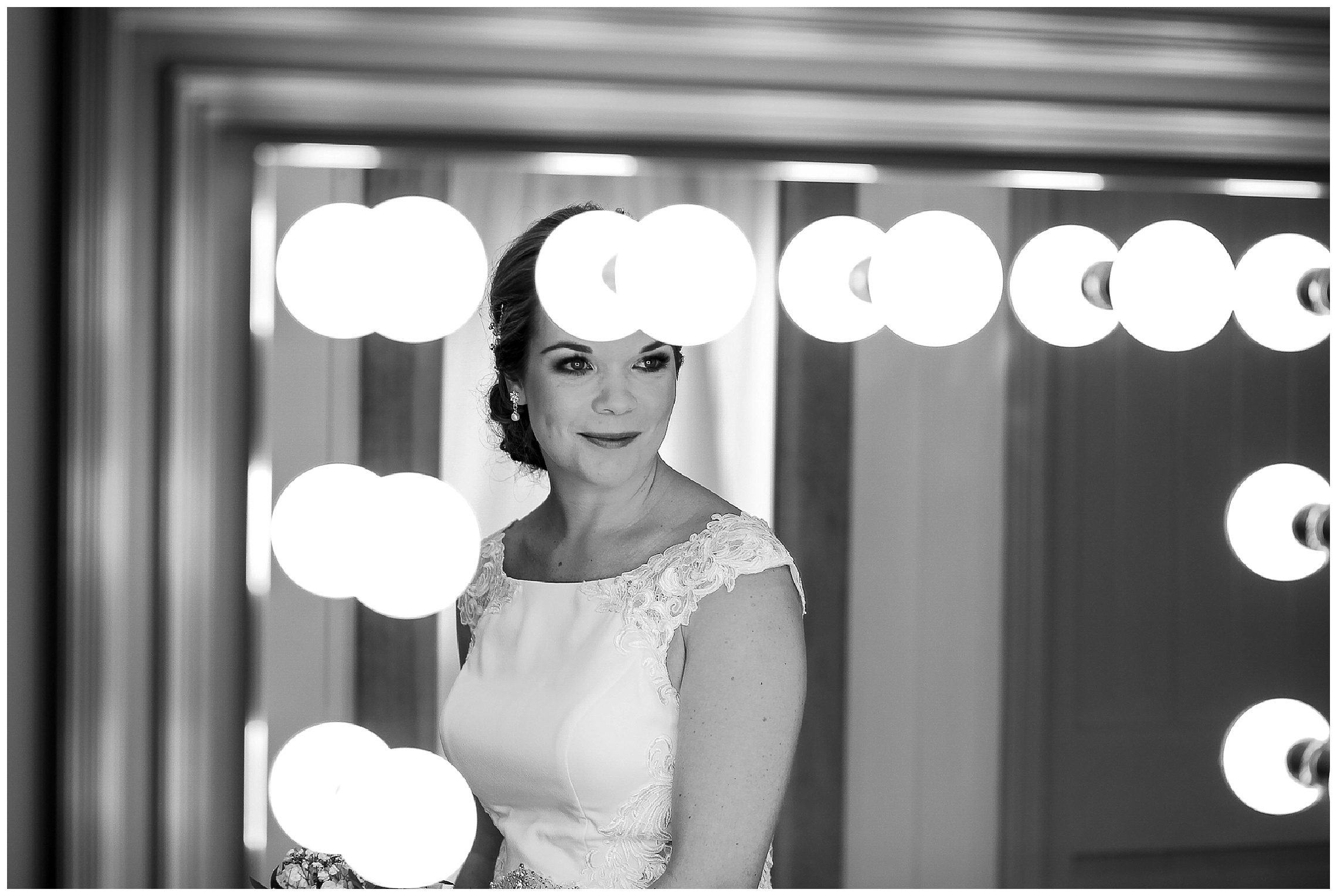 Bride looks at herself in the mirror
