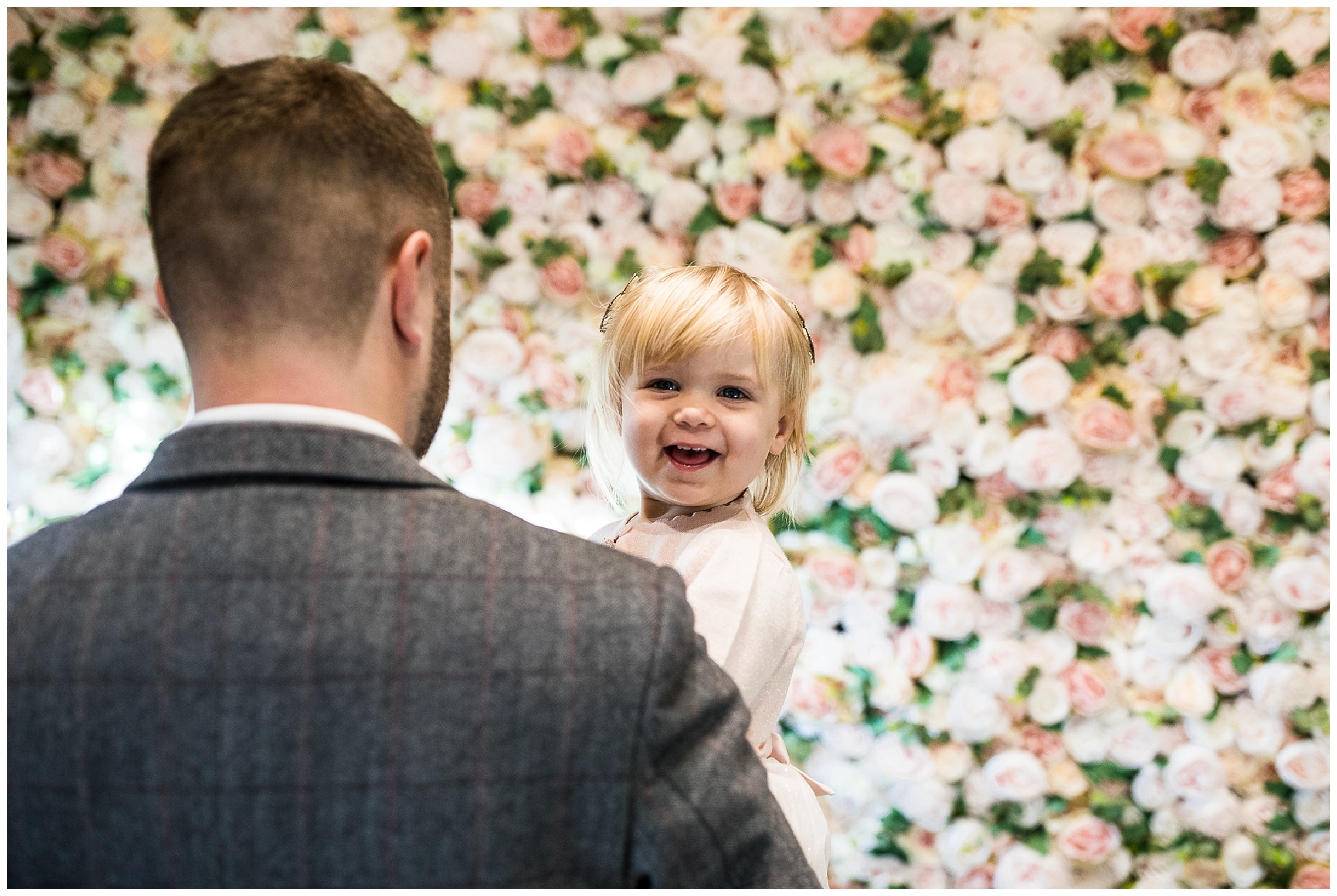 Daughter of the bride and groom smiling