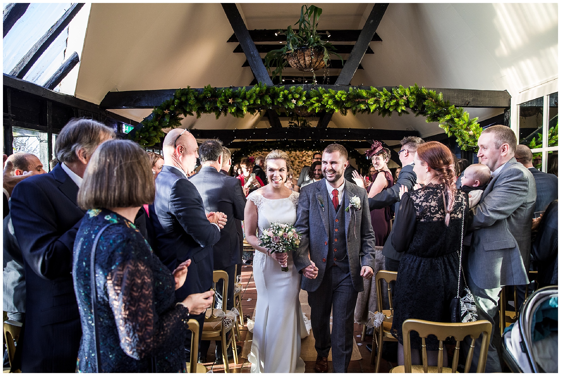 bride and groom leave wedding ceremony arm in arm