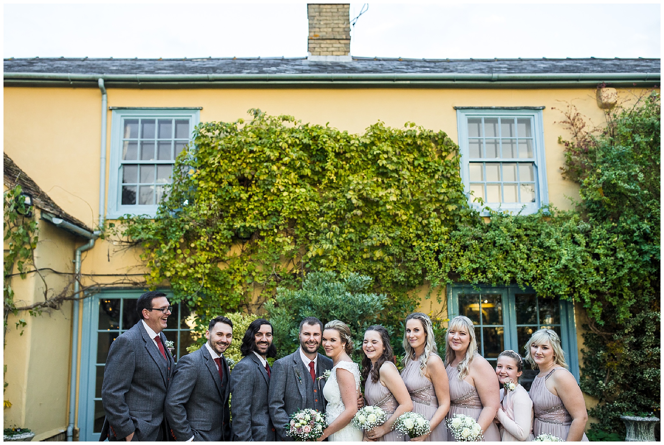 groomsmen and bridesmaids smiling at south farm wedding venue