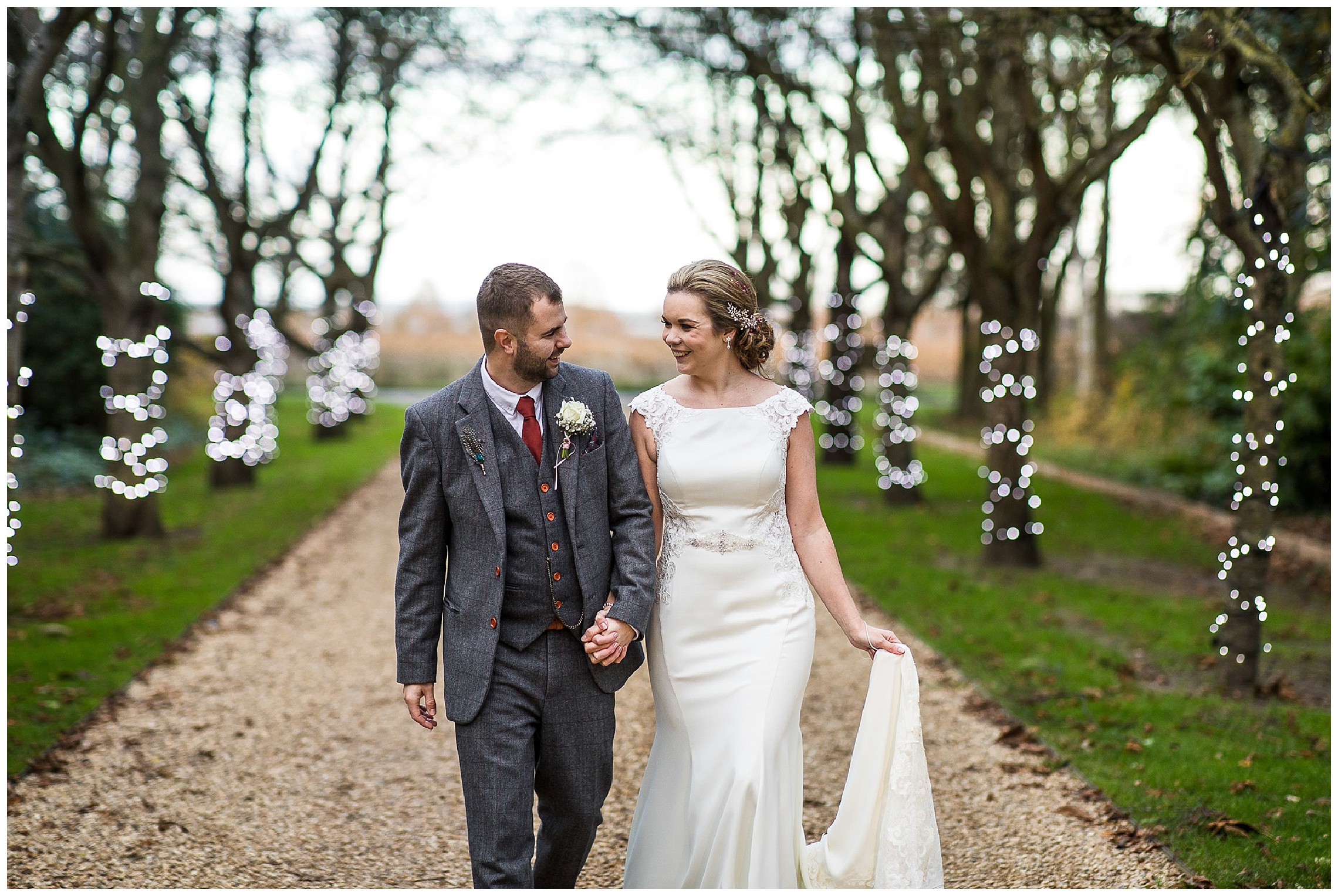 Bride and groom walking together and smiling at one another