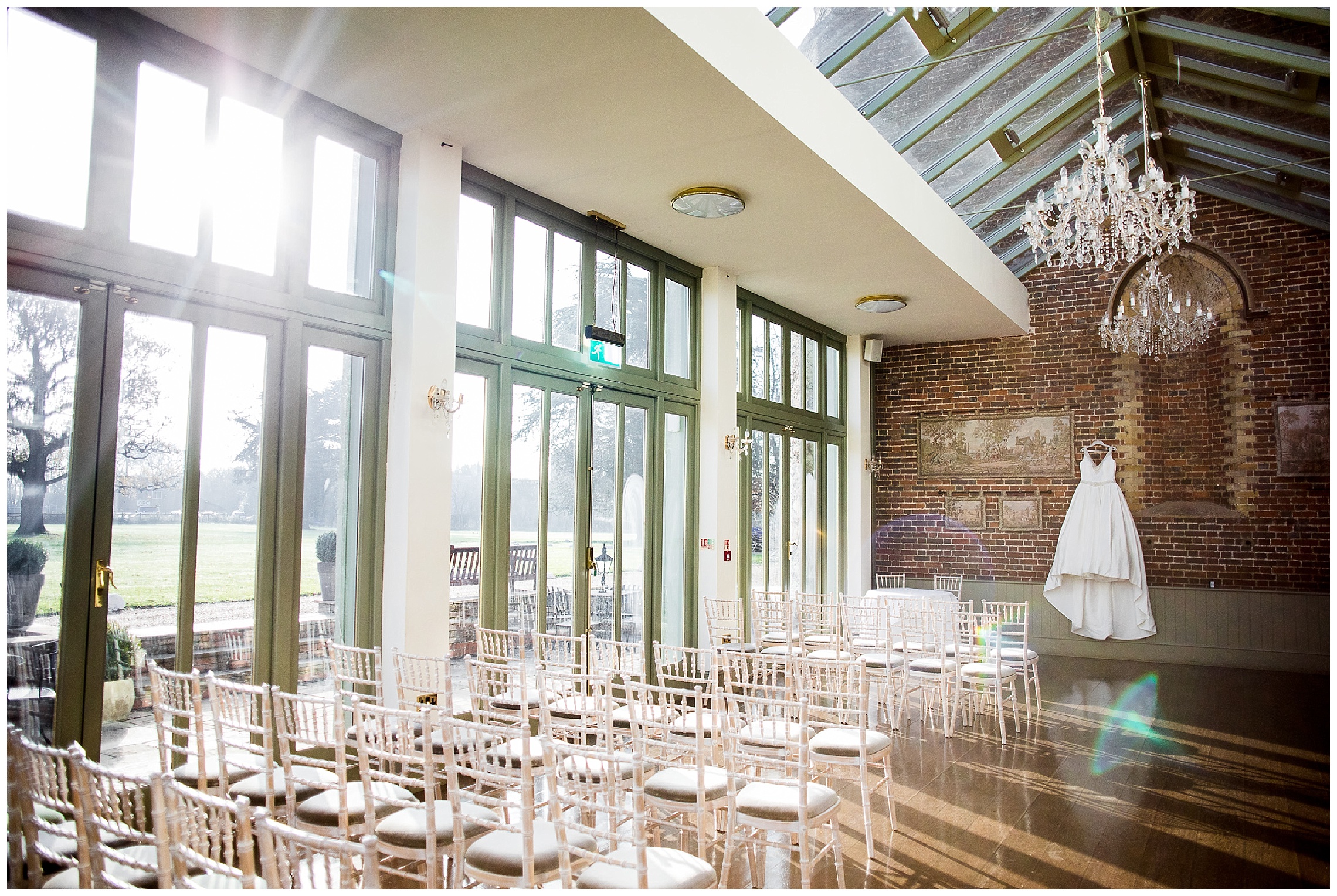 wedding dress hanging in flared light at offset place wedding venue