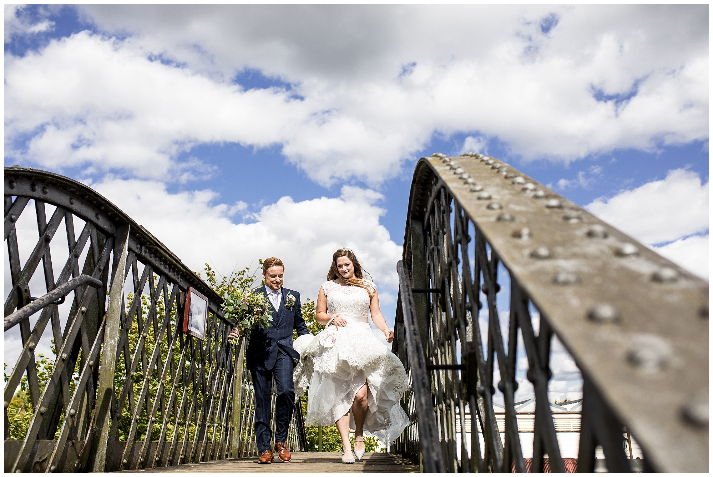 bride and groom walk together other iron bridge at bucks railway centre