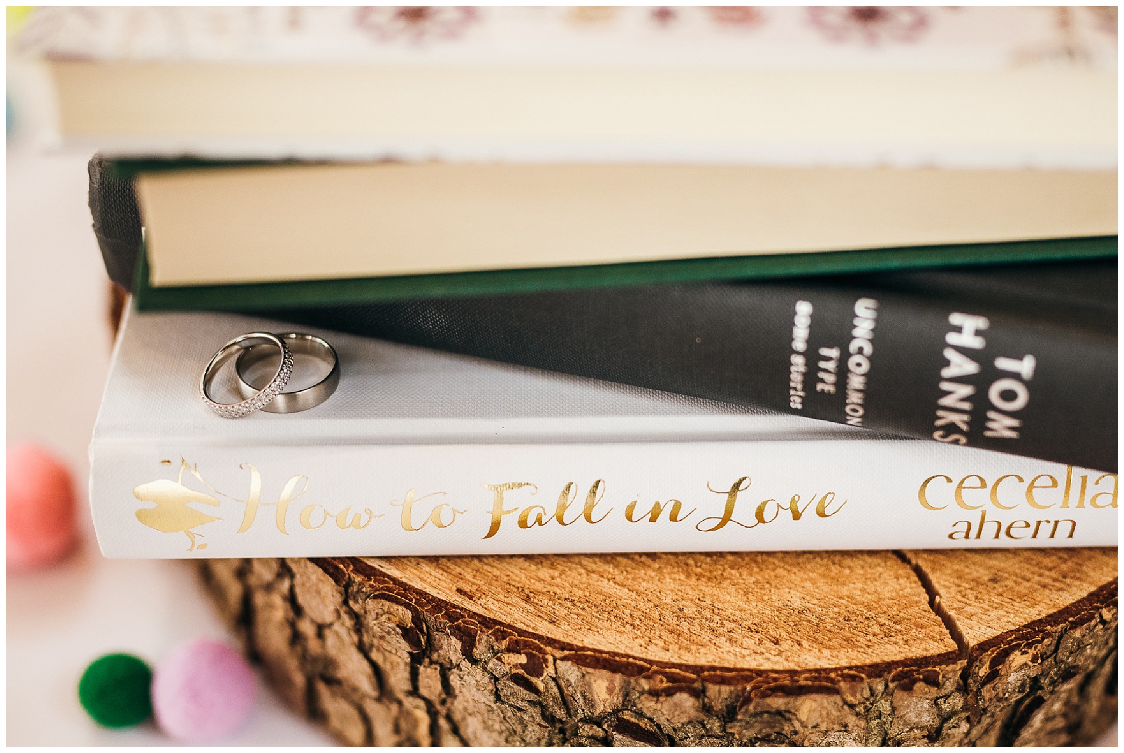 silver wedding rings on literature, forming wedding centrepiece at bassmead