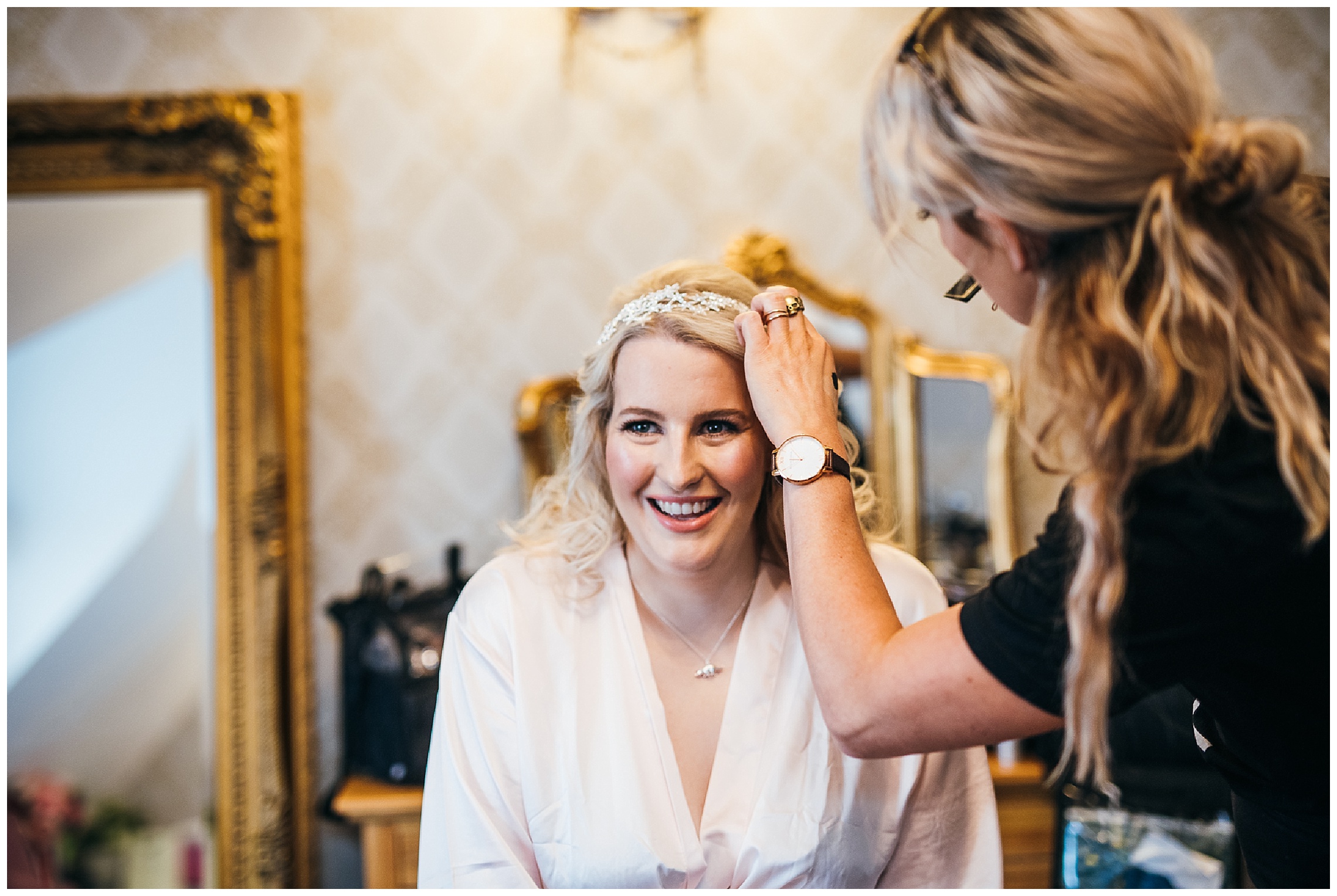 bride smiles as tiara made of stars is placed on her head