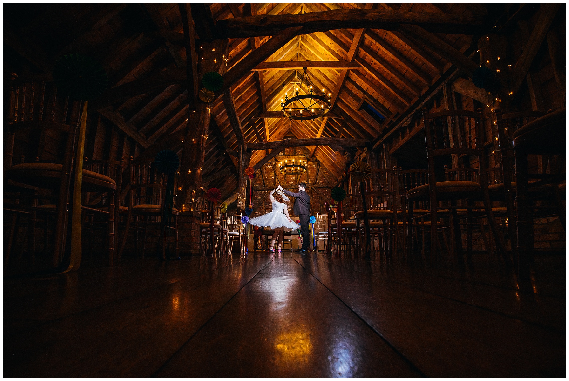 bride and groom dance in dark rickety barn at bassmead