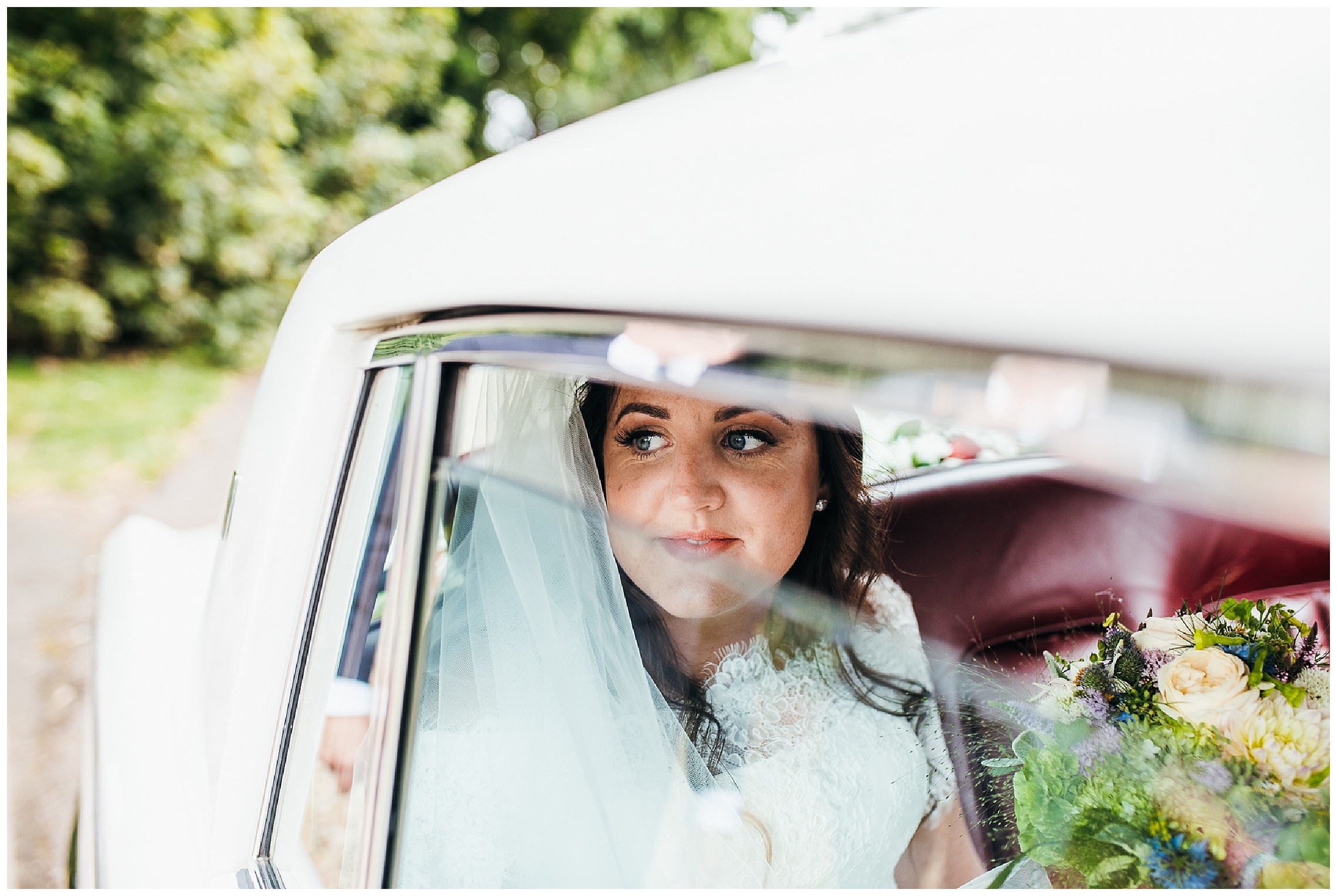 Bride nervously smiles and looks out of window as she arrives to wedding ceremony at hunsbury hill