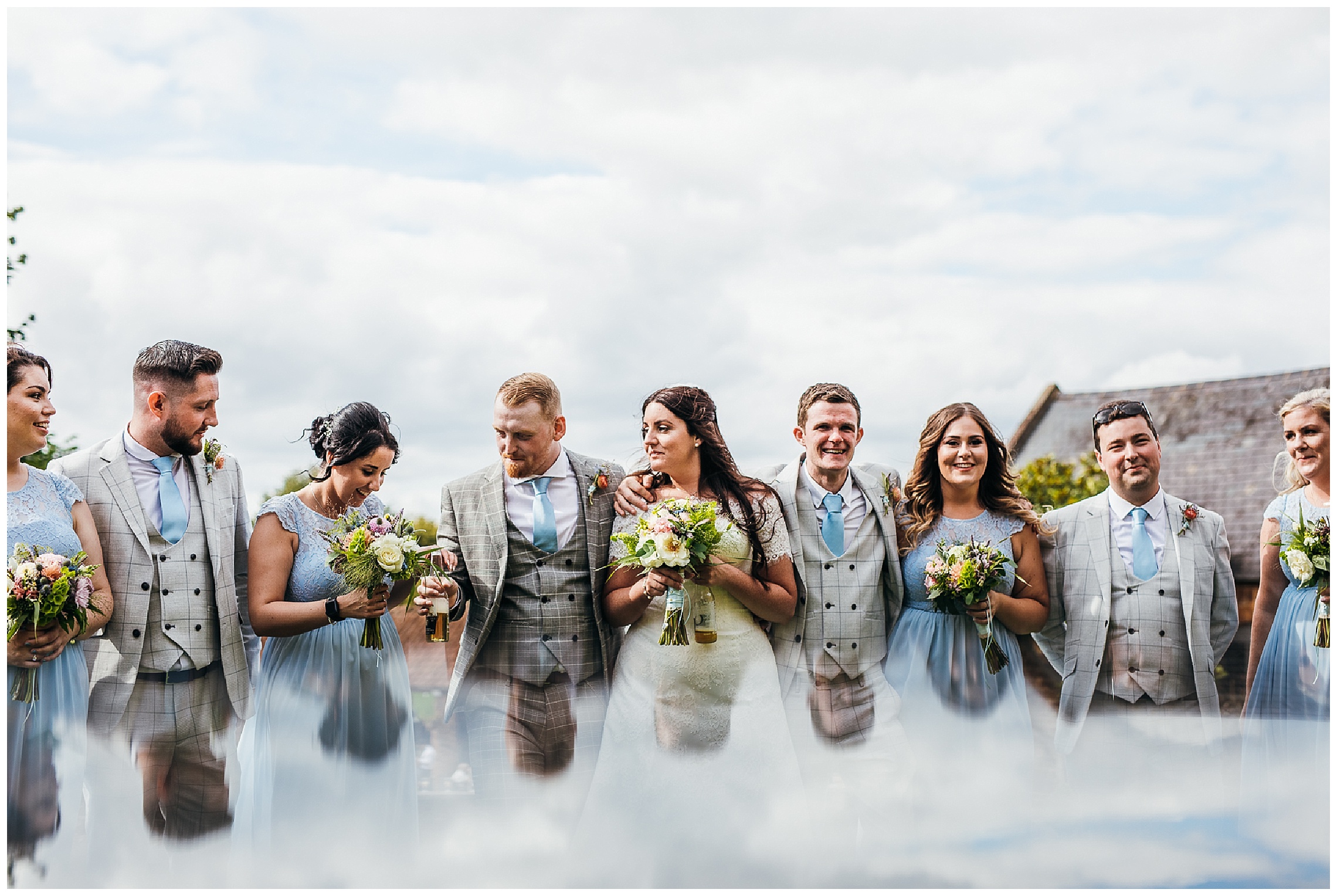 groomsmen in grey suits and bridesmaids in blue dresses at hunsbury hill