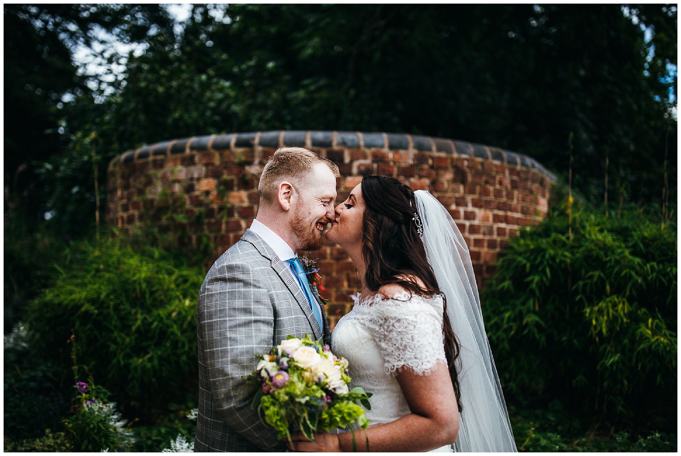 Bride kisses groom on nose as he laughs on their wedding day