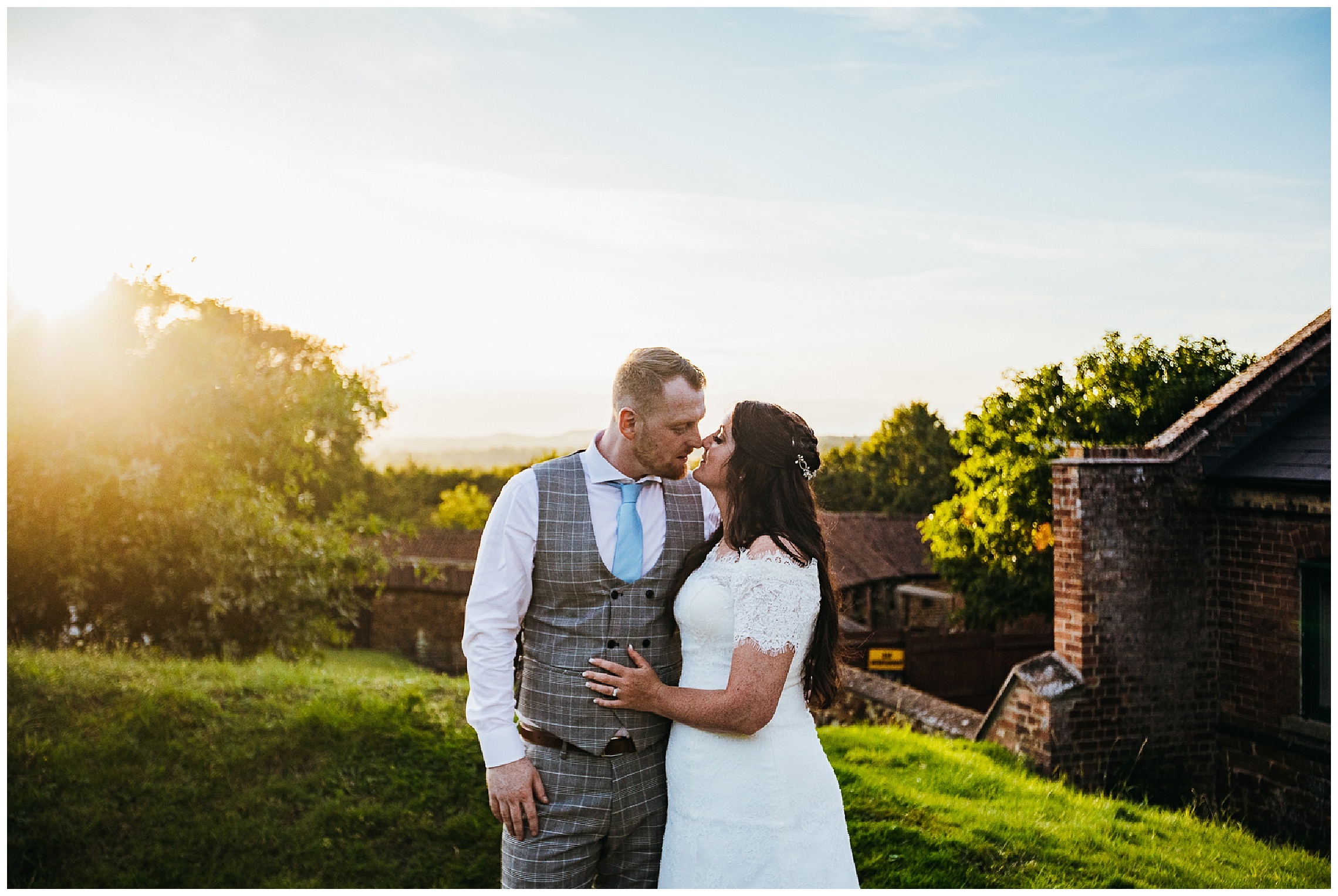 bride and groom embracing in front of sunset at golden hour in hunsbury hill