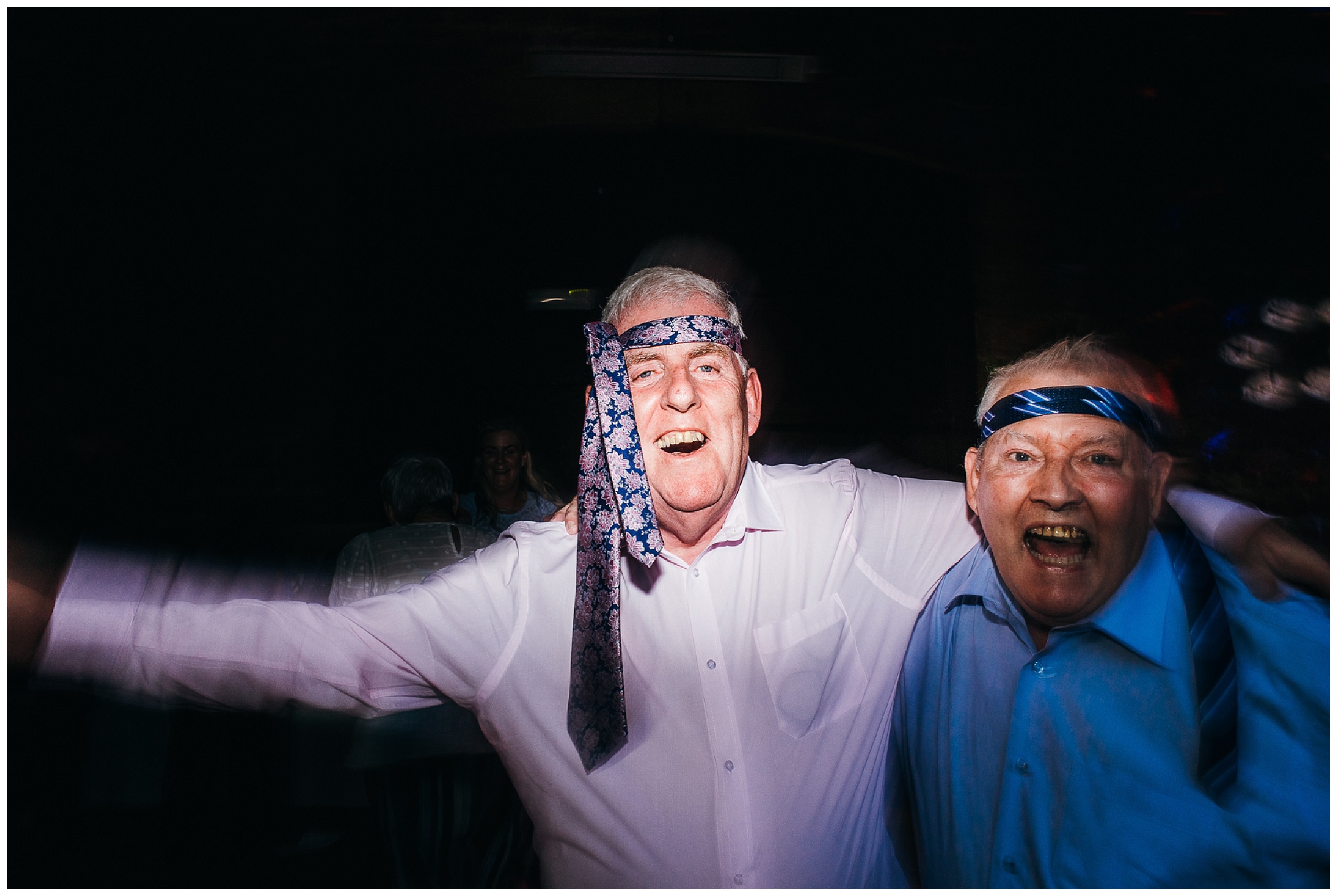 wedding guests dancing with ties around their heads