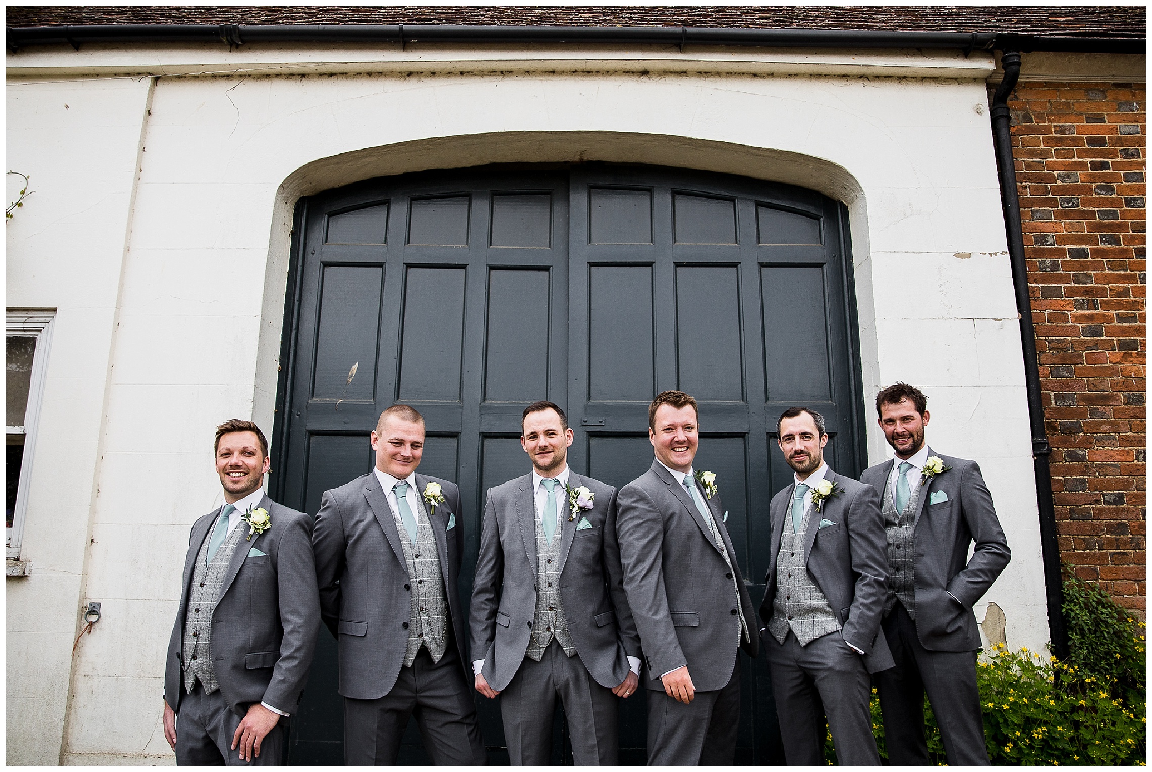 Groomsmen and groom in grey suits with mint ties
