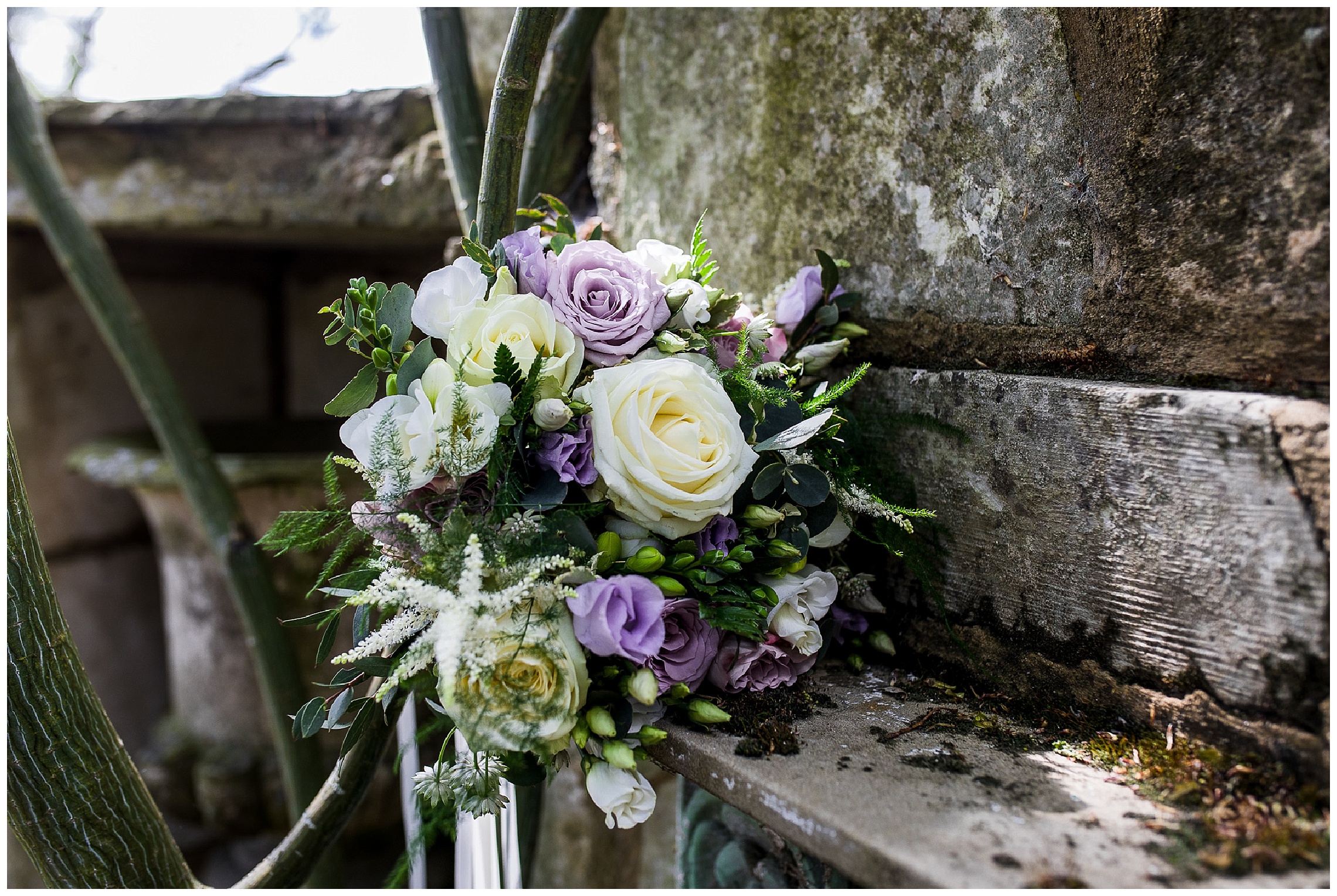 Spring wedding bouquet of purple and white with foiliage