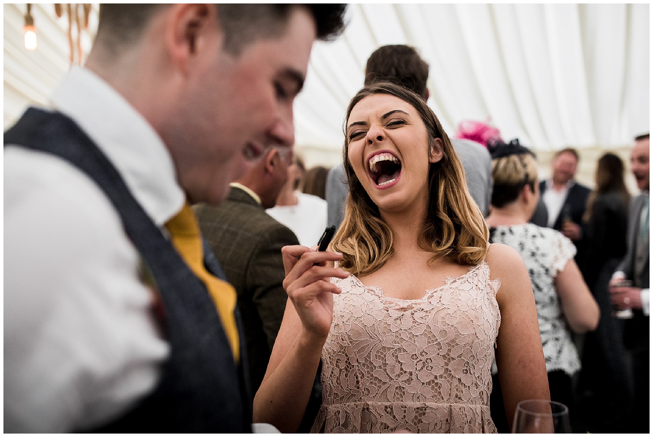 Guest in peach dress laughs