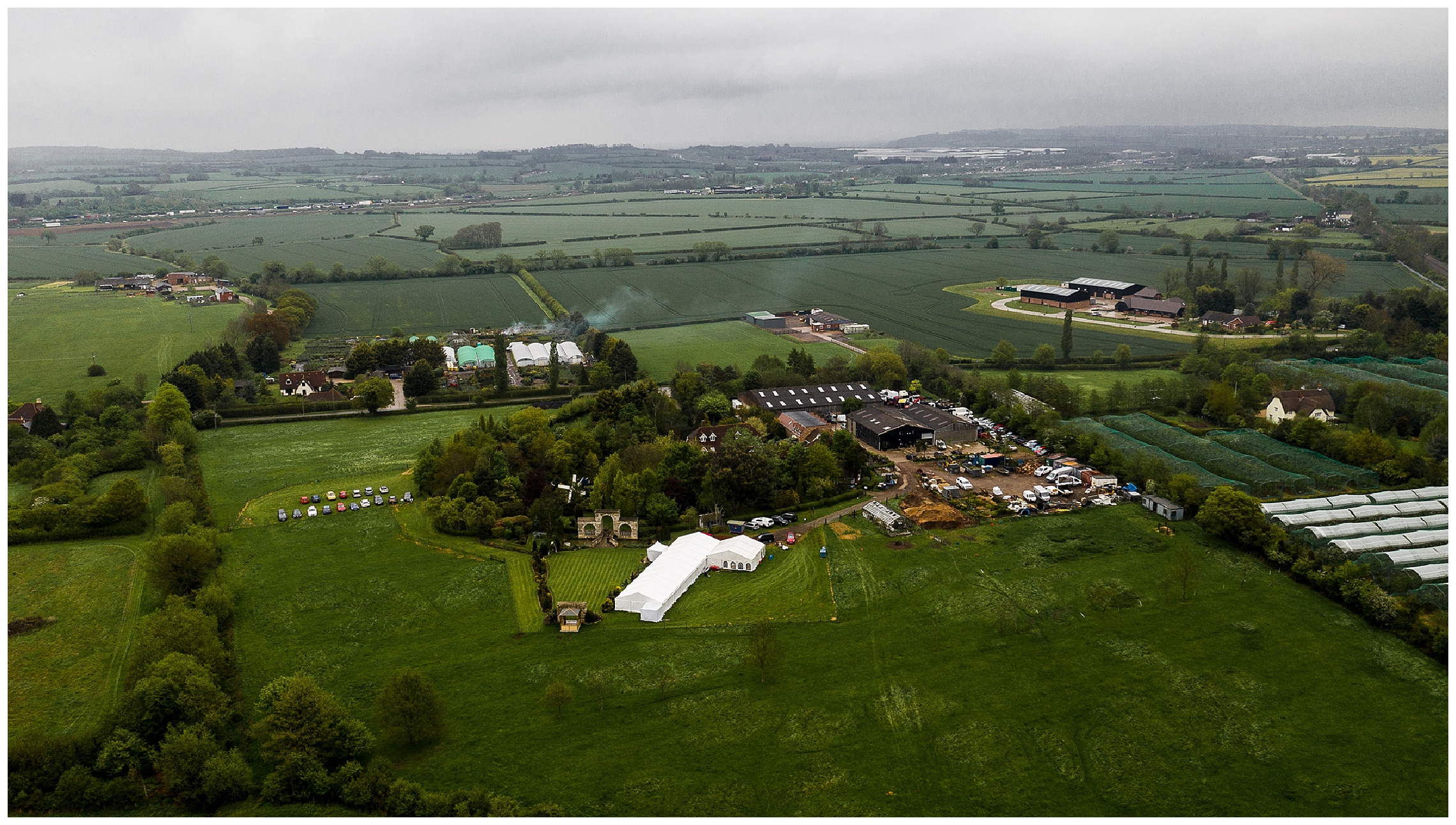 aerial shot of flaxbourne marquee wedding venue surrounded by lawns