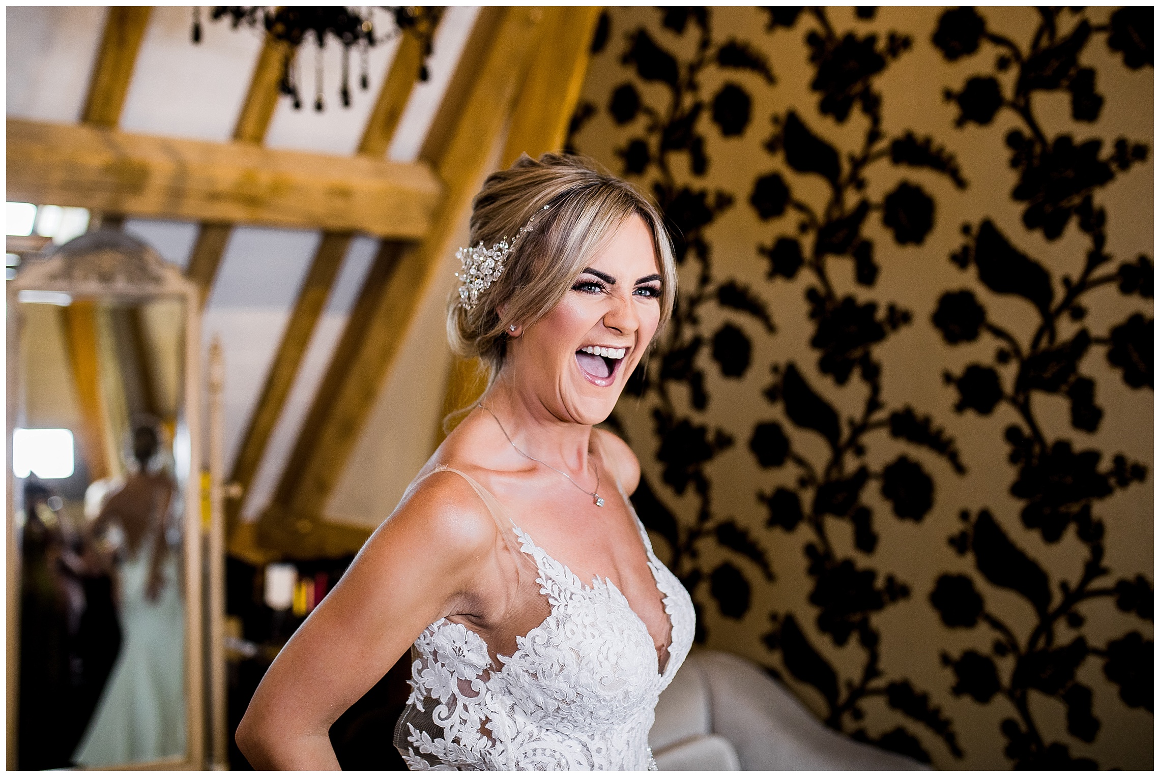blonde bride smiling in thin strap wedding dress at redhouse barn